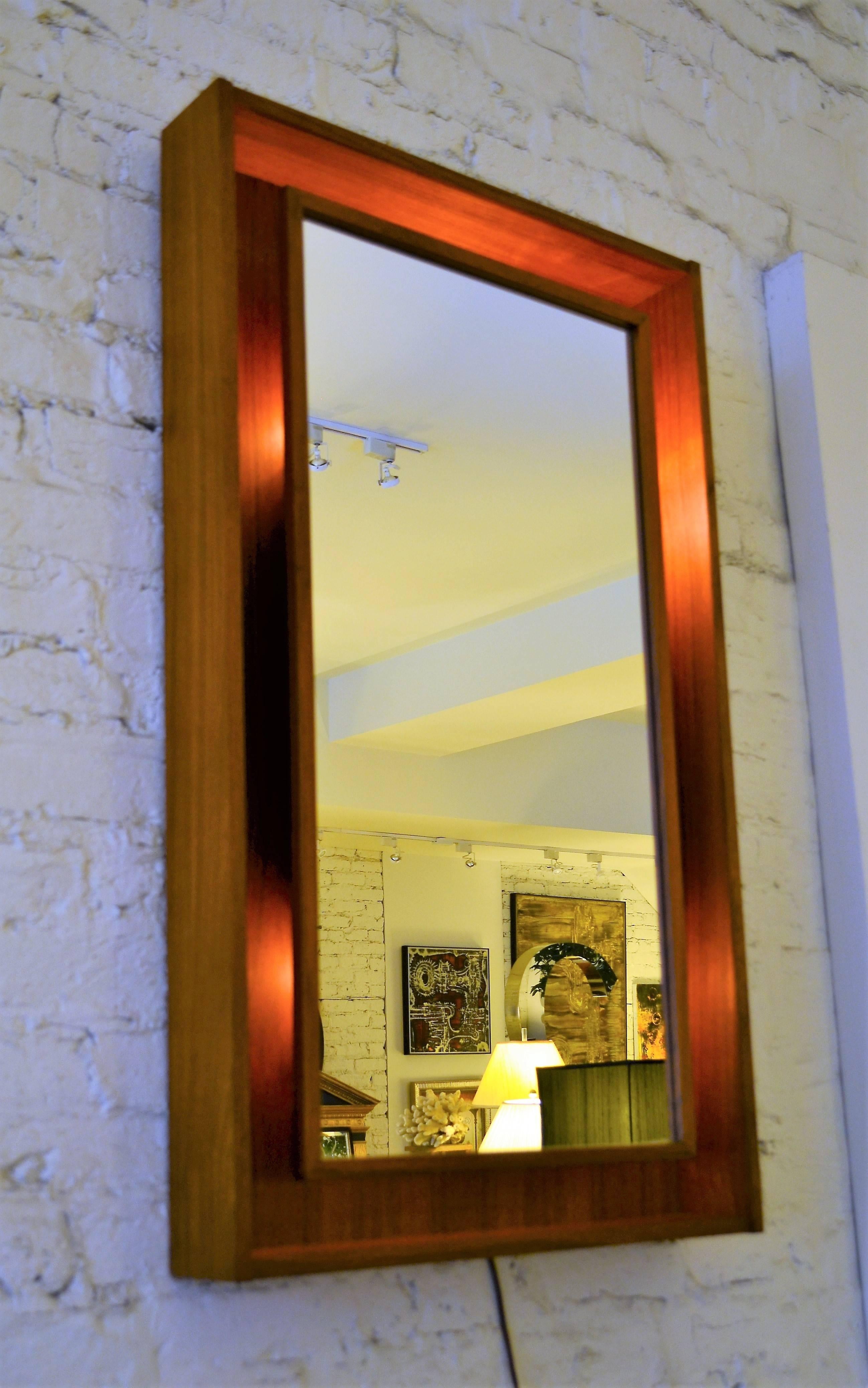 Danish teak mirror by Pedersen & Hansen. This finely crafted mirror floats in a shadow box frame. Quality workmanship throughout. The mirror is back lite.
 