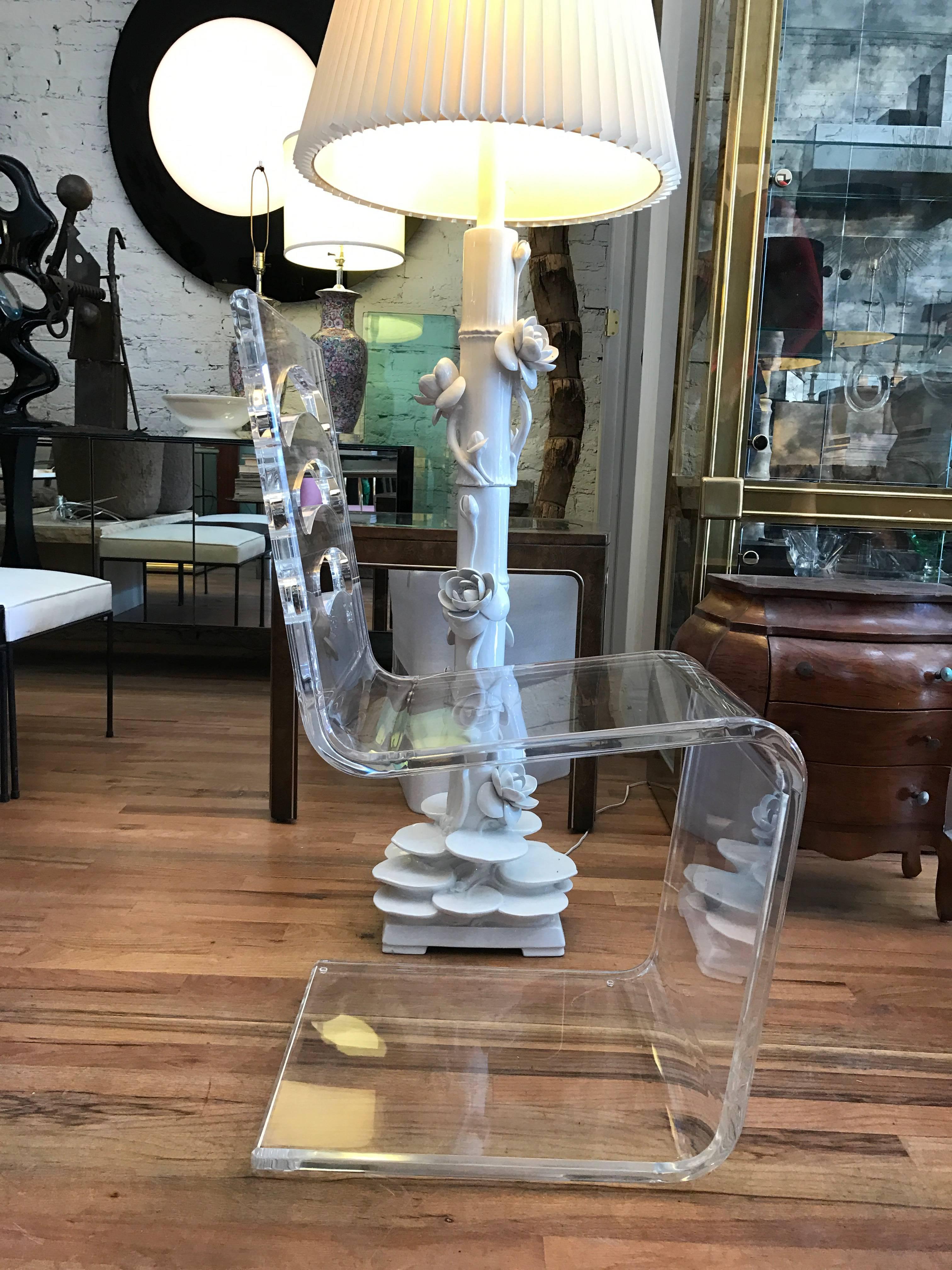 Lucite side chairs in the manner of Charles Hollis Jones. The chairs are price individually at $2800 each. One back features a cut-out checkerboard and the other three cut-out curved arches. These chairs are exceptionally thick and because they were