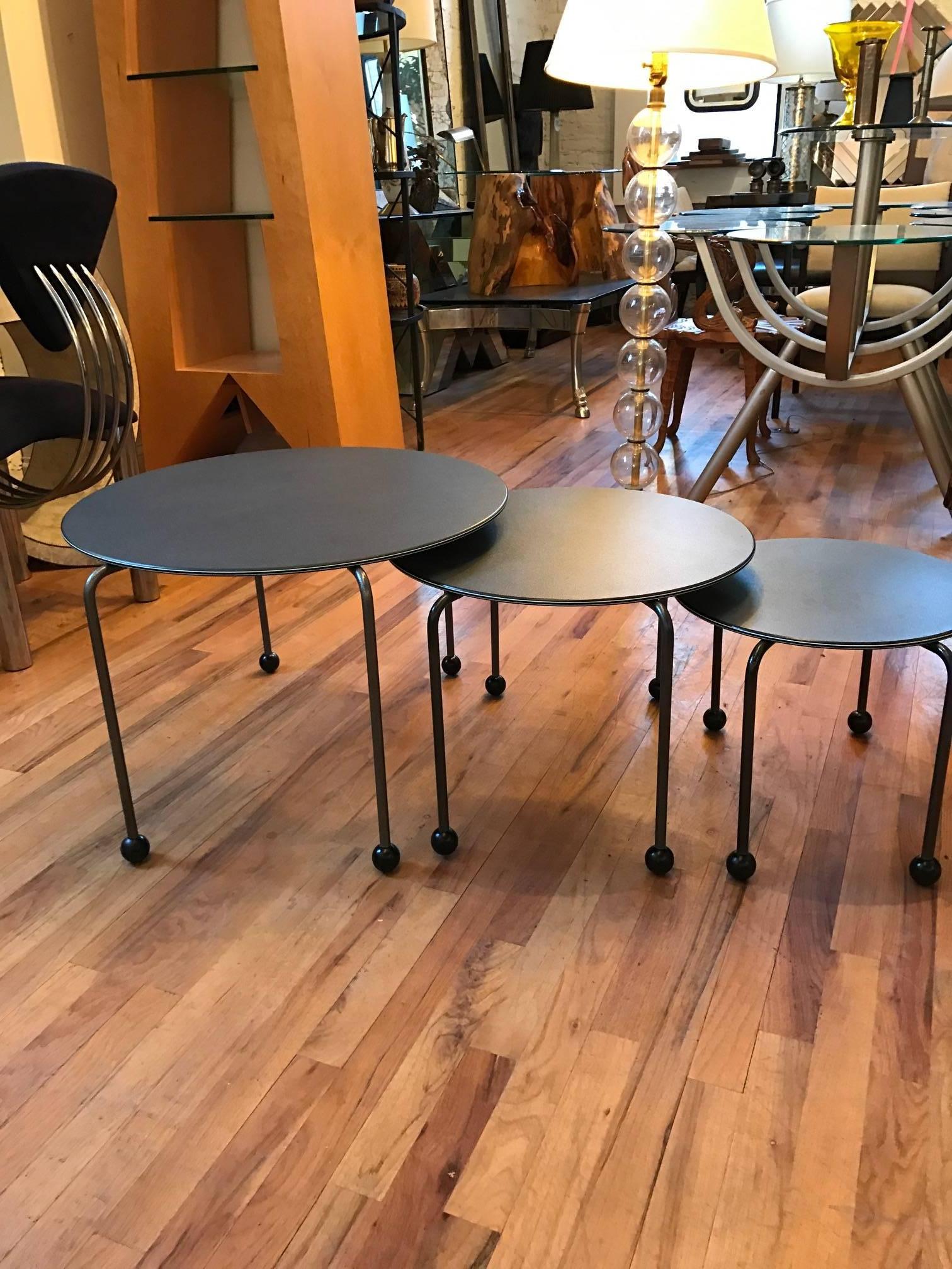 A highly versatile set of Postmodern tables in the manner of Ettore Sottsass and Michele De Lucchi. Would also work well as a coffee table. The tables have enameled wood tops, enameled metal legs, and lacquered wood ball feet.
Dimensions of the