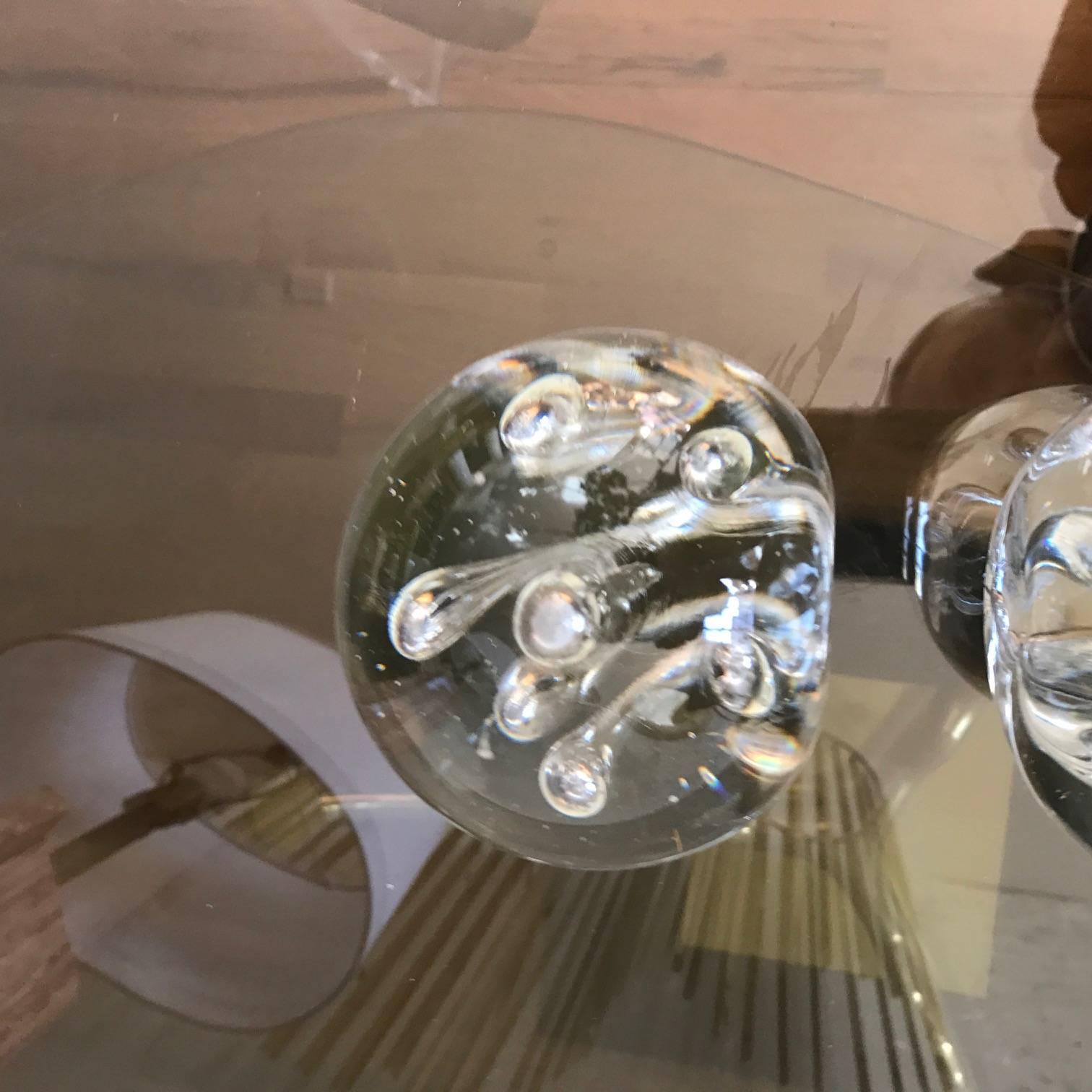 Highly unusual large egg shaped Murano spheres with elongated controlled bubble inclusions. These are exceptionally heavy.