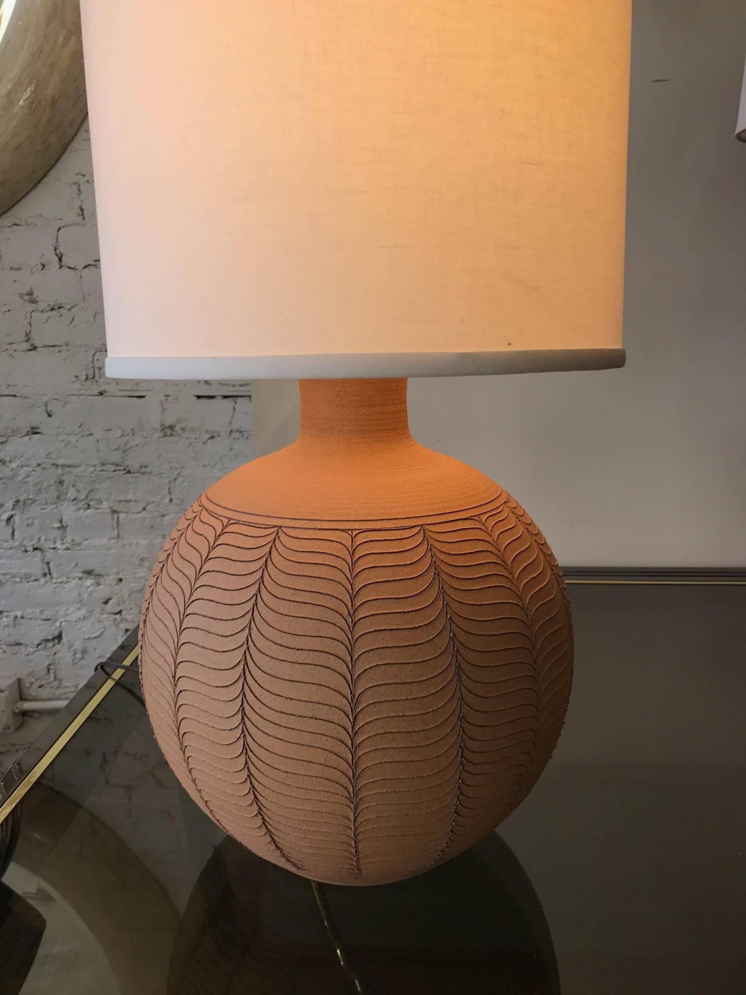 An organic stoneware terra cotta Mid-Century  lamp in the manner of David Cressey. The handcrafted lamp is signed Brown. Lampshade not included.