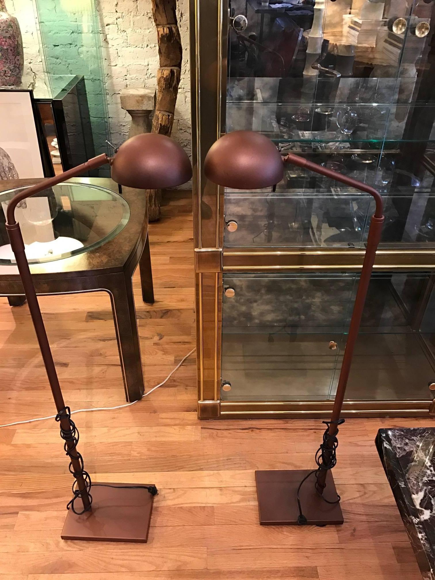 Kovacs floor lamps designed by Robert Sonneman. The adjustable pair of  lamps have a brownish enameled finish. The heads pivot and have Halogen lights.