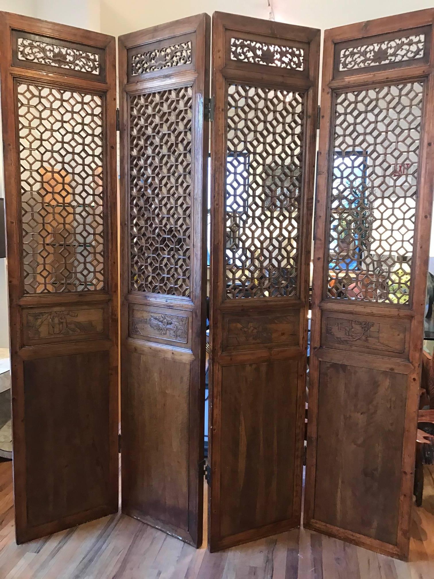 Set of four Chinese courtyard doors. Each screen has an intricate geometric lattice top panel above a solid bottom panel. Each door has a central unique carved panel in low relief. Exquisite mortice and tenons joinery. These screens are mid-19th