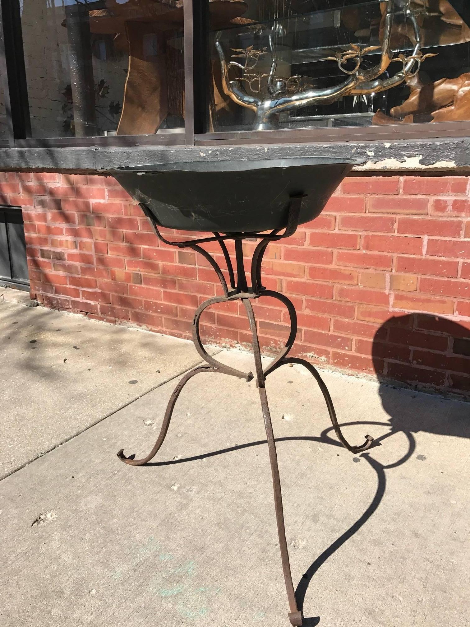 Wrought iron 18th Century plant stand. It might be earlier.
Fantastic simple rustic design. Highly sculptural would also make for a great bird bath.