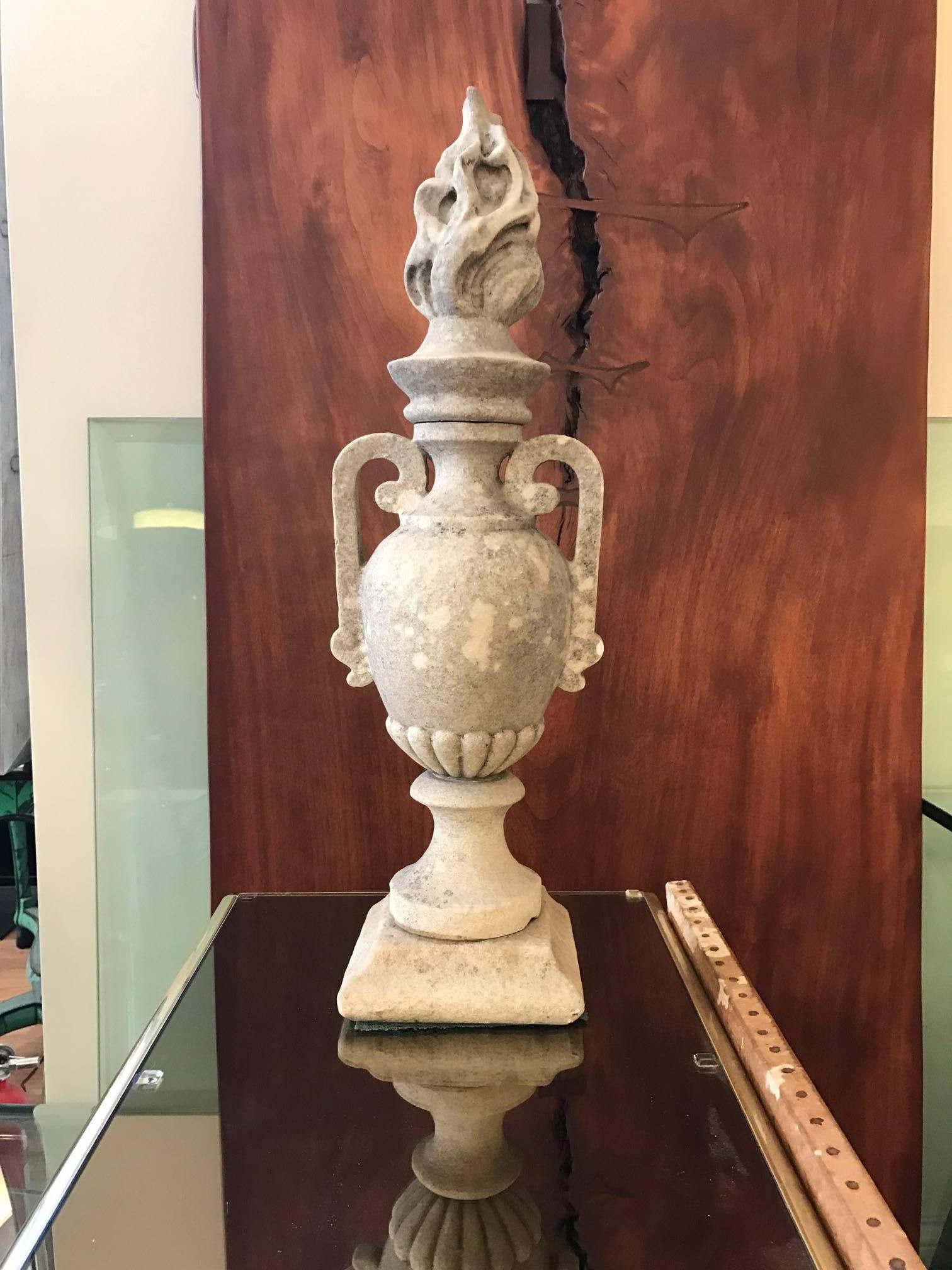 Carved 19th century sold marble garden urn with pierced handles on its sides. The top is caped with a fantastic carved flame. Versatile decorative element in the home or garden.