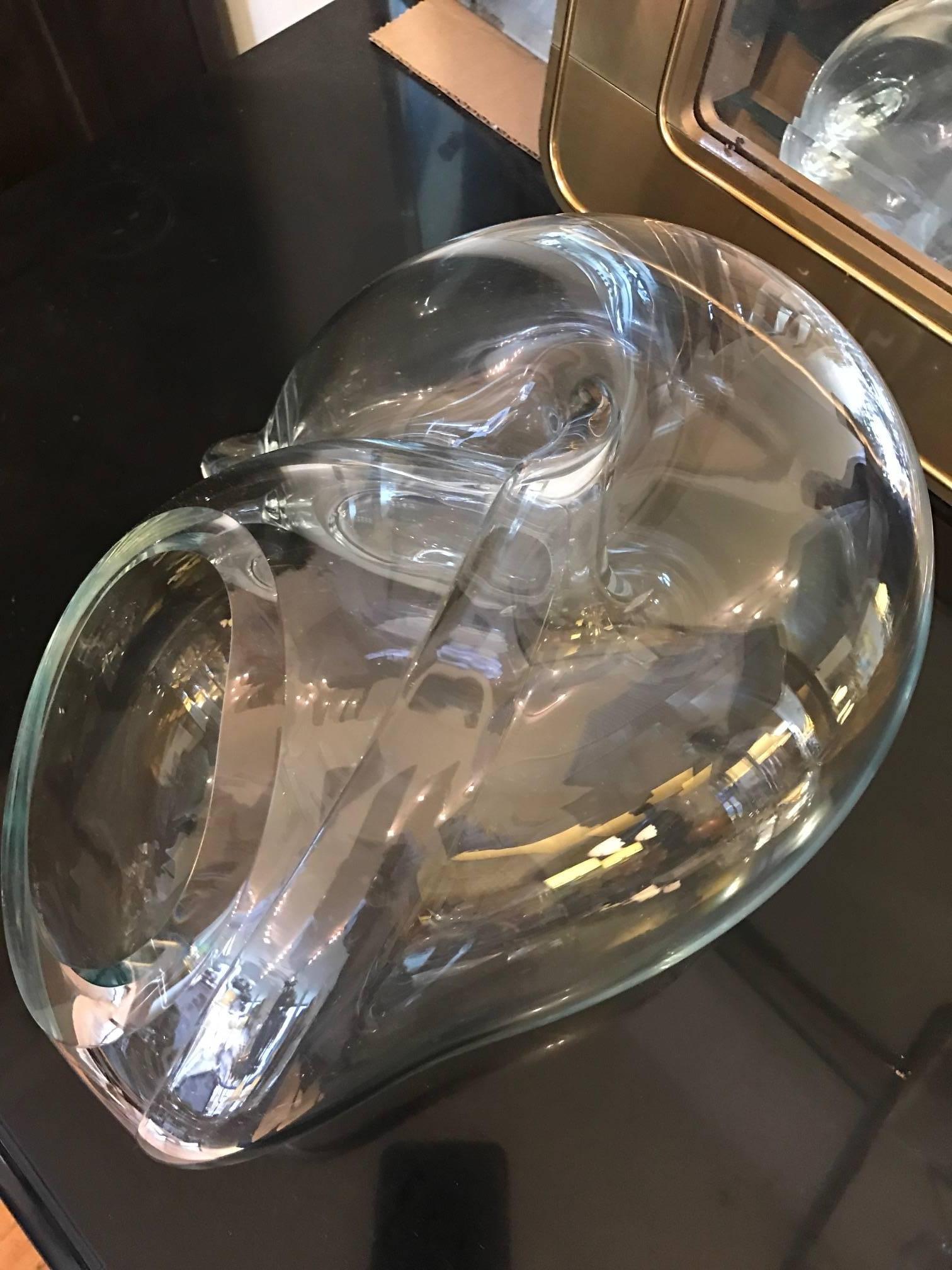 A highly curvaceous glass decorative object by American studio glass artist John Bingham. This handblown versatile piece could be used either as a sculpture or a vase.
 