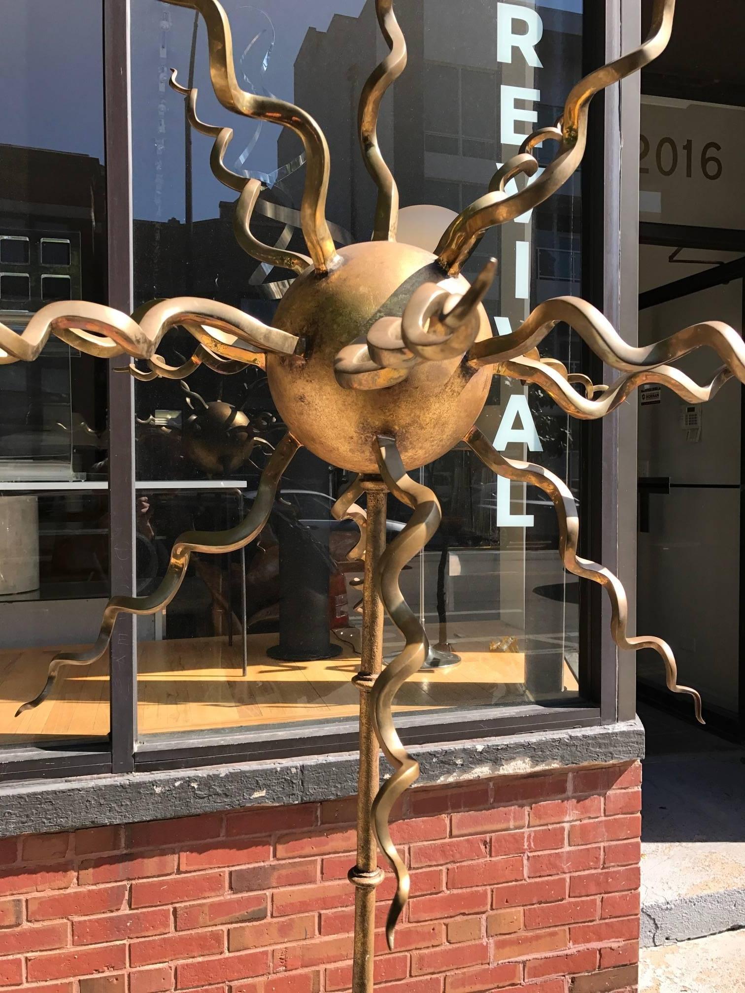 Tony Duquette style Brutalist abstract totem sculpture. This large well crafted work is constructed of iron and rests on a carved star-shaped stone base. The iron is accentuated by gilt. Fantastic overall patina.