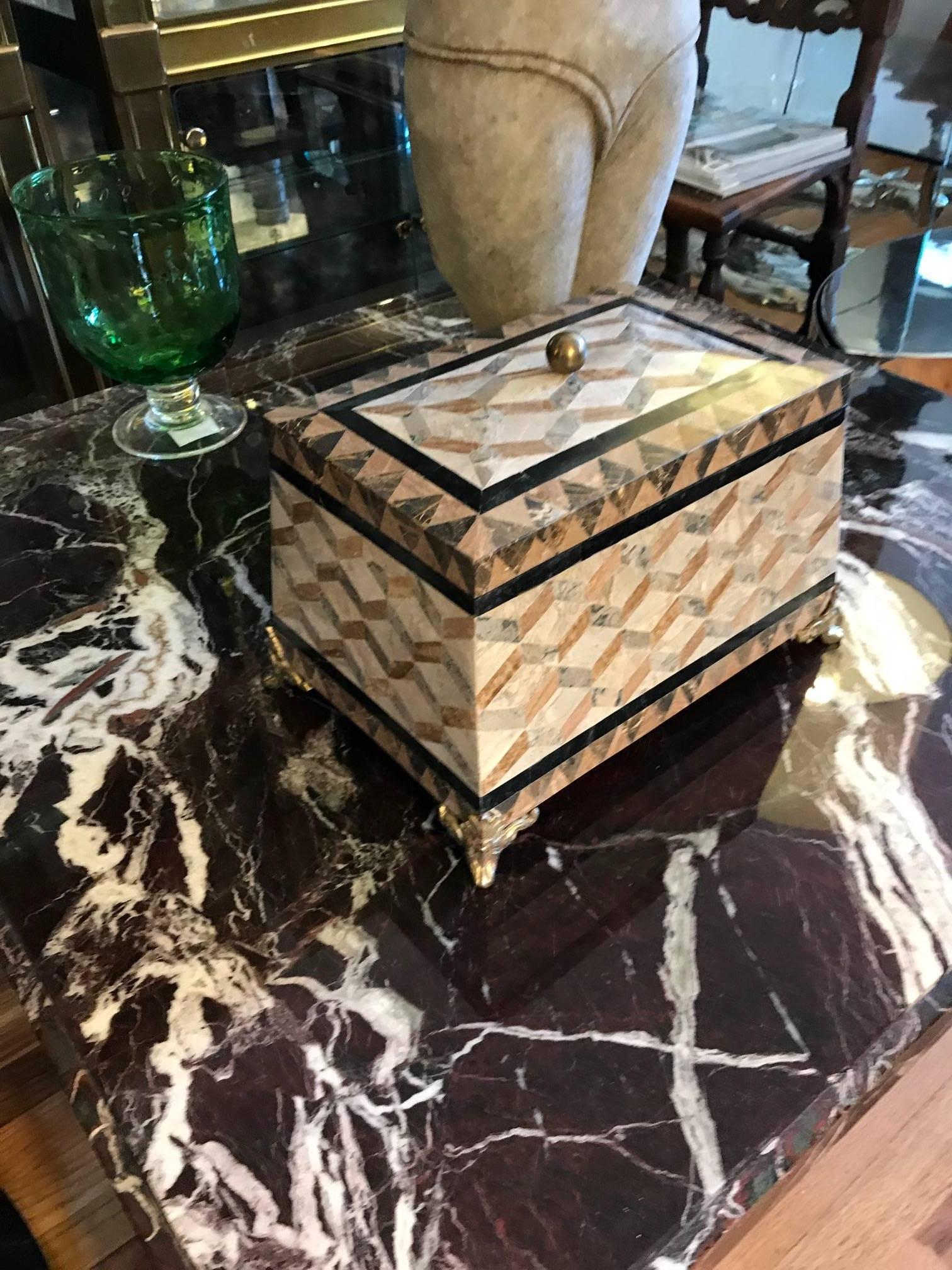 A large and impressive tessolated stone box by Maitland Smith. The interior is wood lined and the box rests on four decorative brass sabots. Finest craftsmanship.