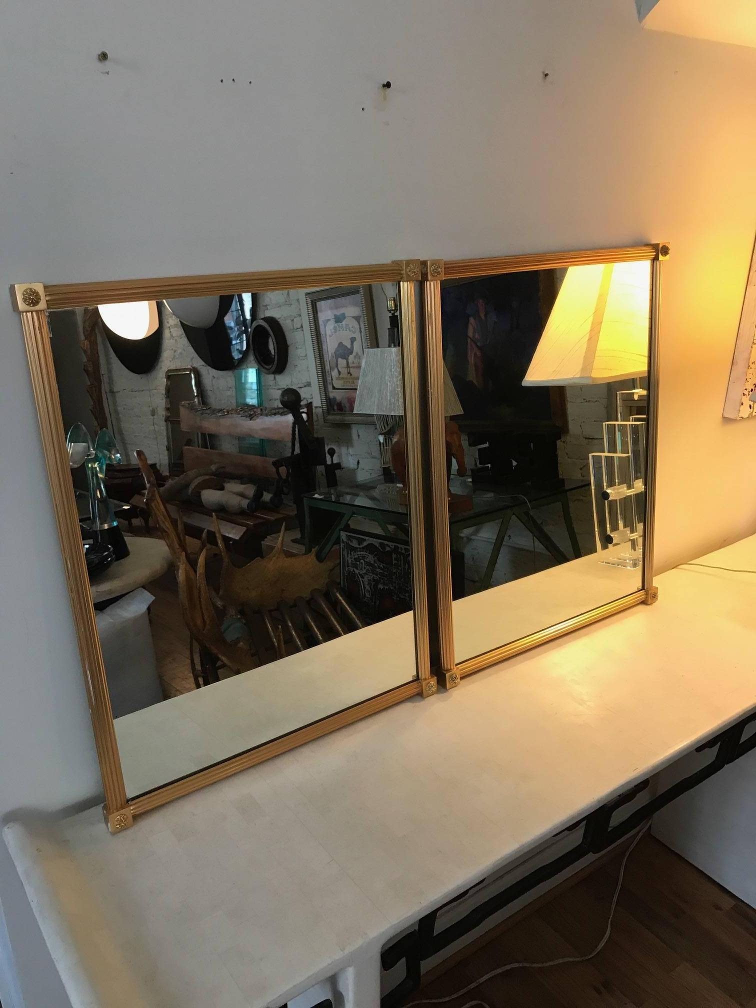 An exceptional pair of sold gilt bronze mirrors by Maison Bagues. These heavy mirrors have fluted frames and four corner rosettes. Finest French craftsmanship.