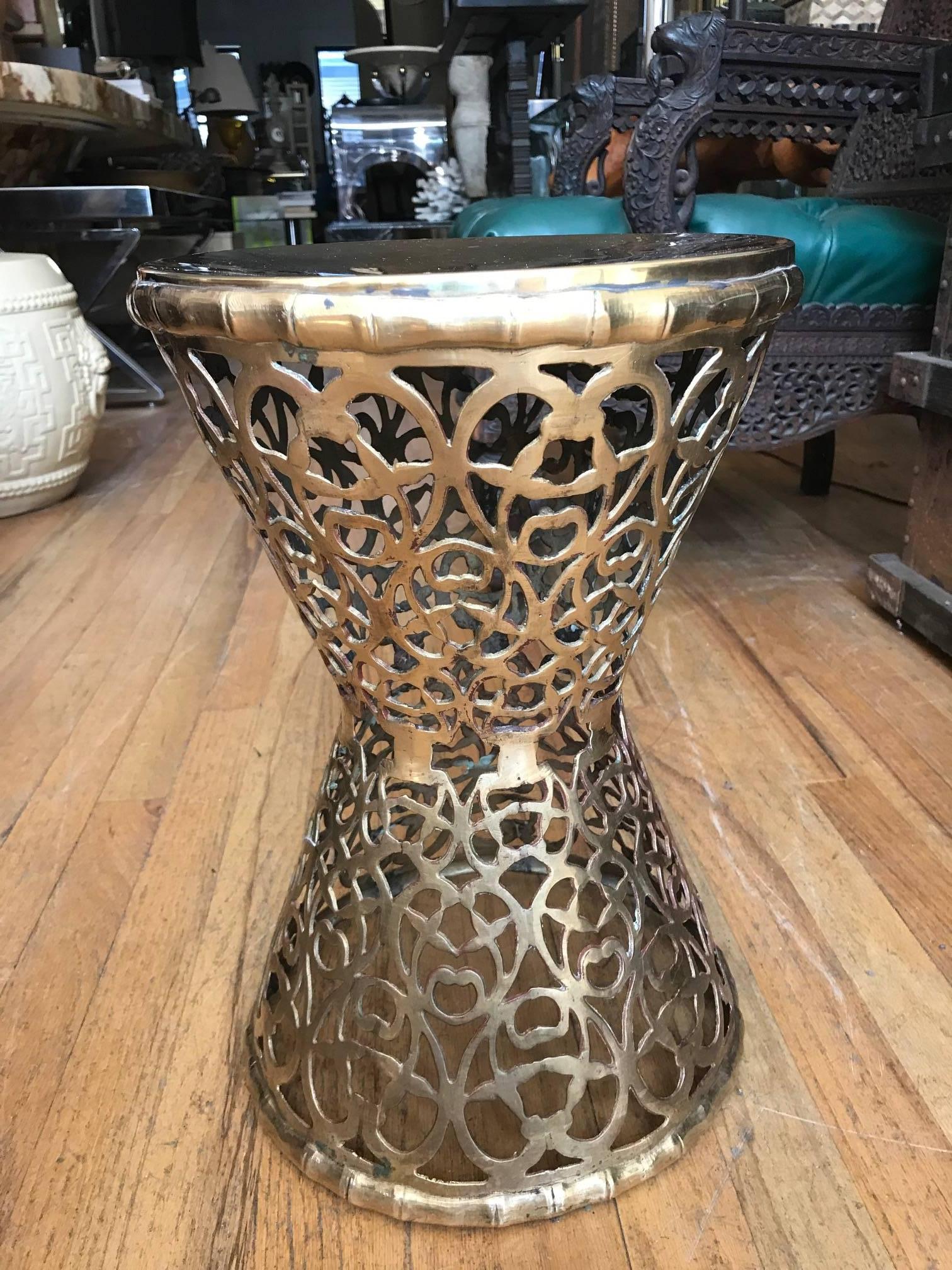 A Moroccan pierced brass hourglass shaped end side table. Might also work as an exotic Moorish garden stool or plant stand.