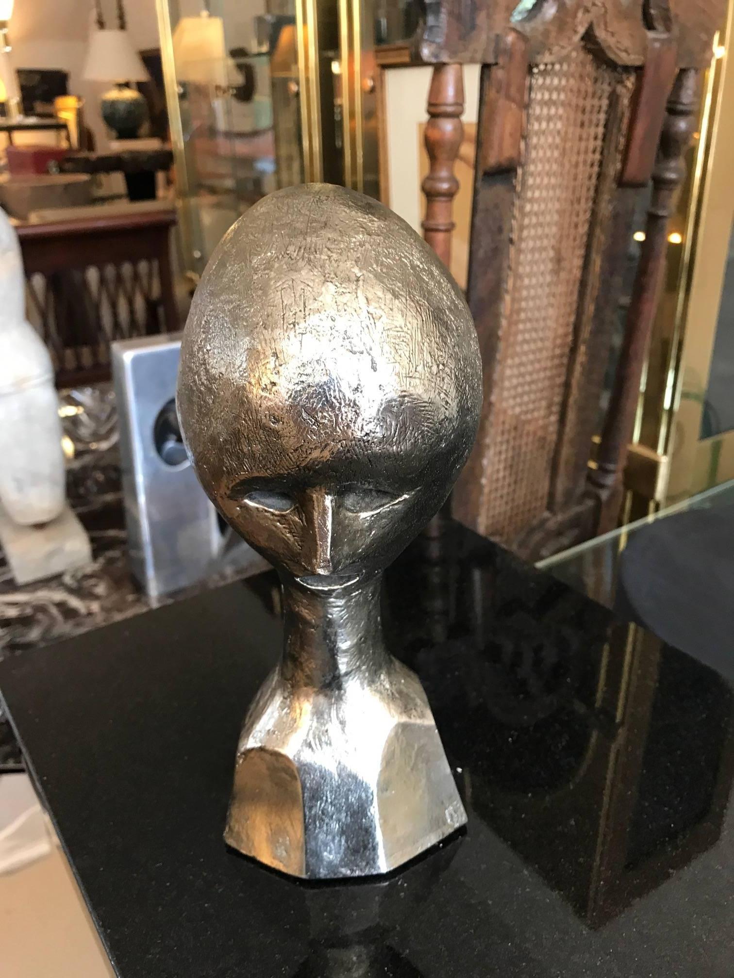 A Mid-Century polished steel abstract male bust. A haunting modernist figural sculpture.
The work is marked on the side MIWAUX Sc.  