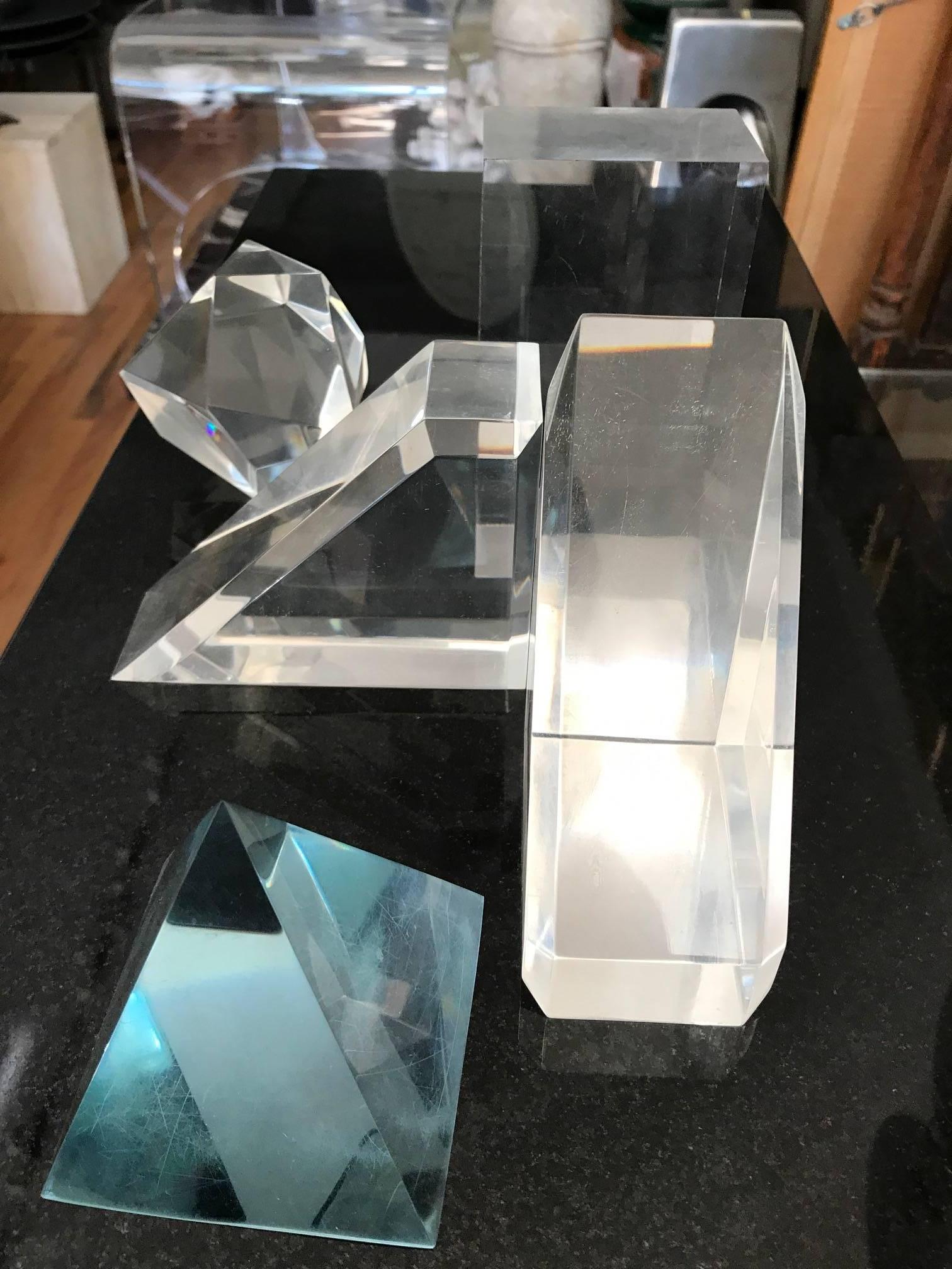 Highly sculptural collection of five Lucite geometric tabletop decorative objects.
The collection consists of rectangle cube, pyramid, two triangles and a 12 sided polygon.
The items measurements are:
Rectangle cube H 5 x L 3 x D 2
Pyramid H 3 x