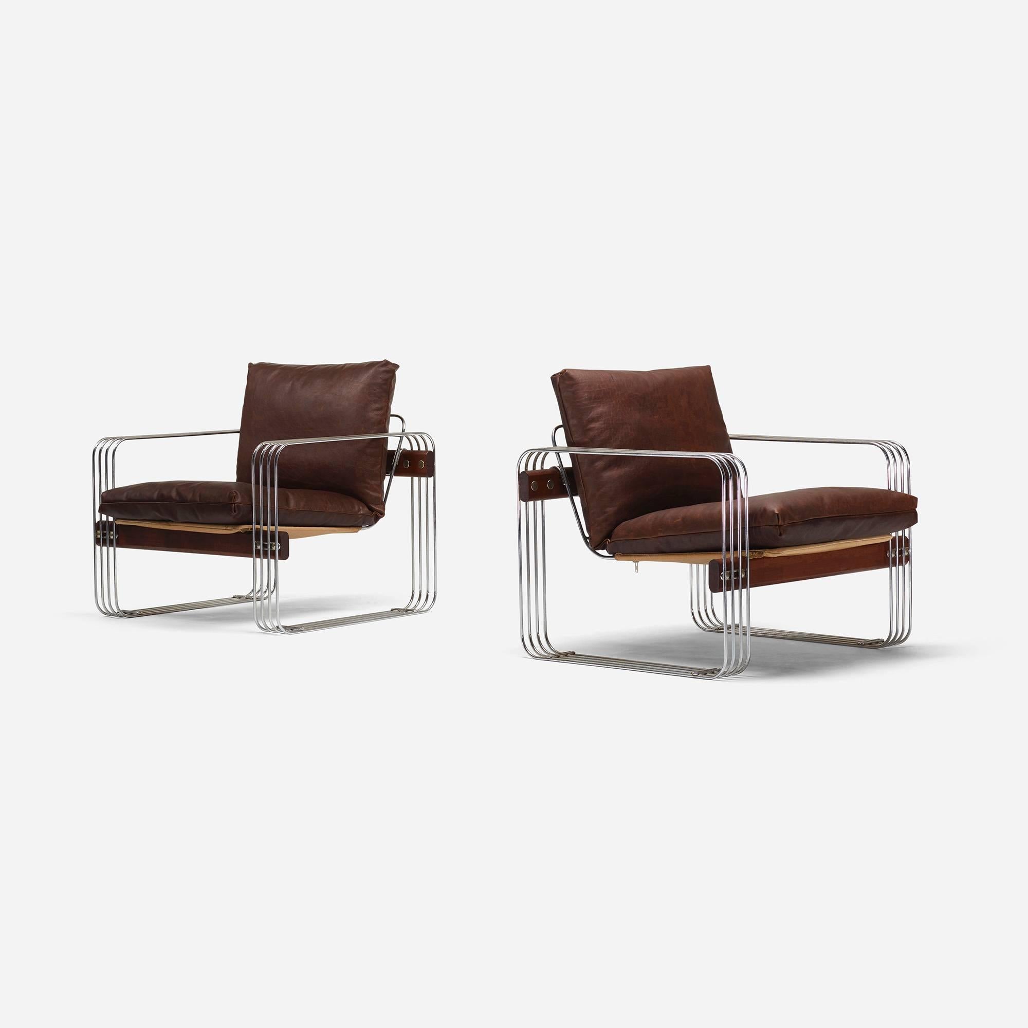 These unusual lounge chairs combine thick, distressed leather, chrome and stained wood.