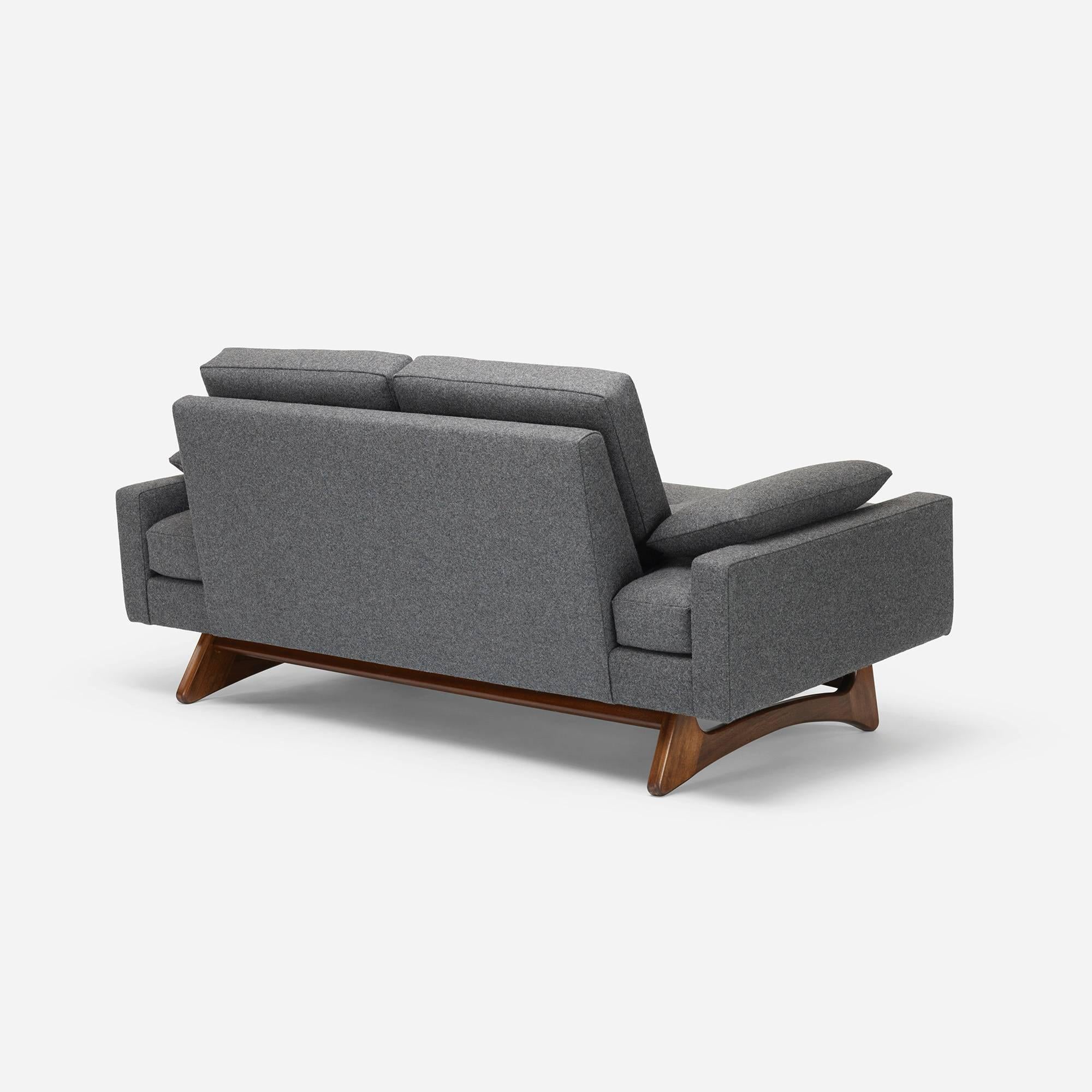 This settee is the smaller version of the well-known model 2408 sofa by Adrian Pearsall. The is the perfect apartment piece, still long enough for most to stretch out on and even serve as a guest bed in a pinch. With a dynamic solid walnut base and