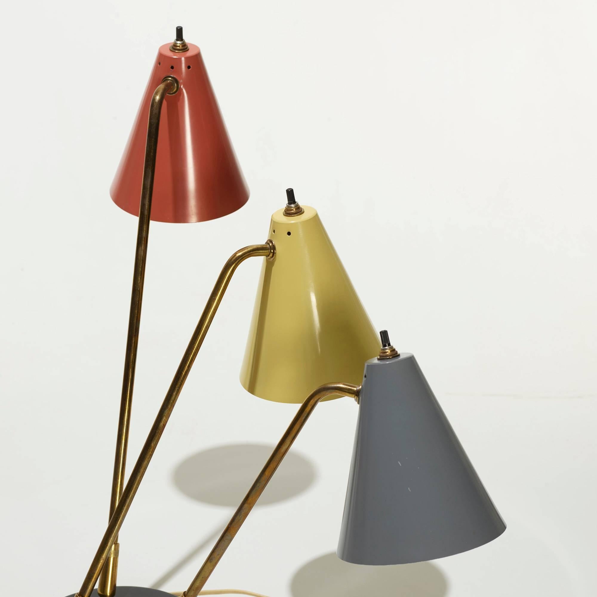 Stylish three-arm table lamps with colored enameled shades.