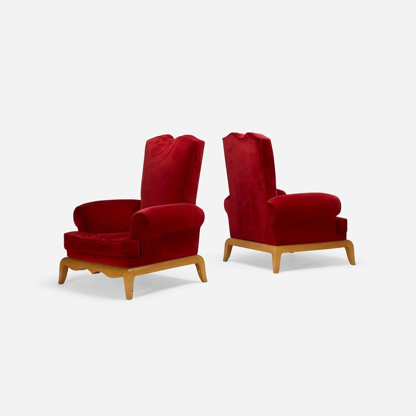 Large-scale French lounge chairs with dramatic carved wood bases.