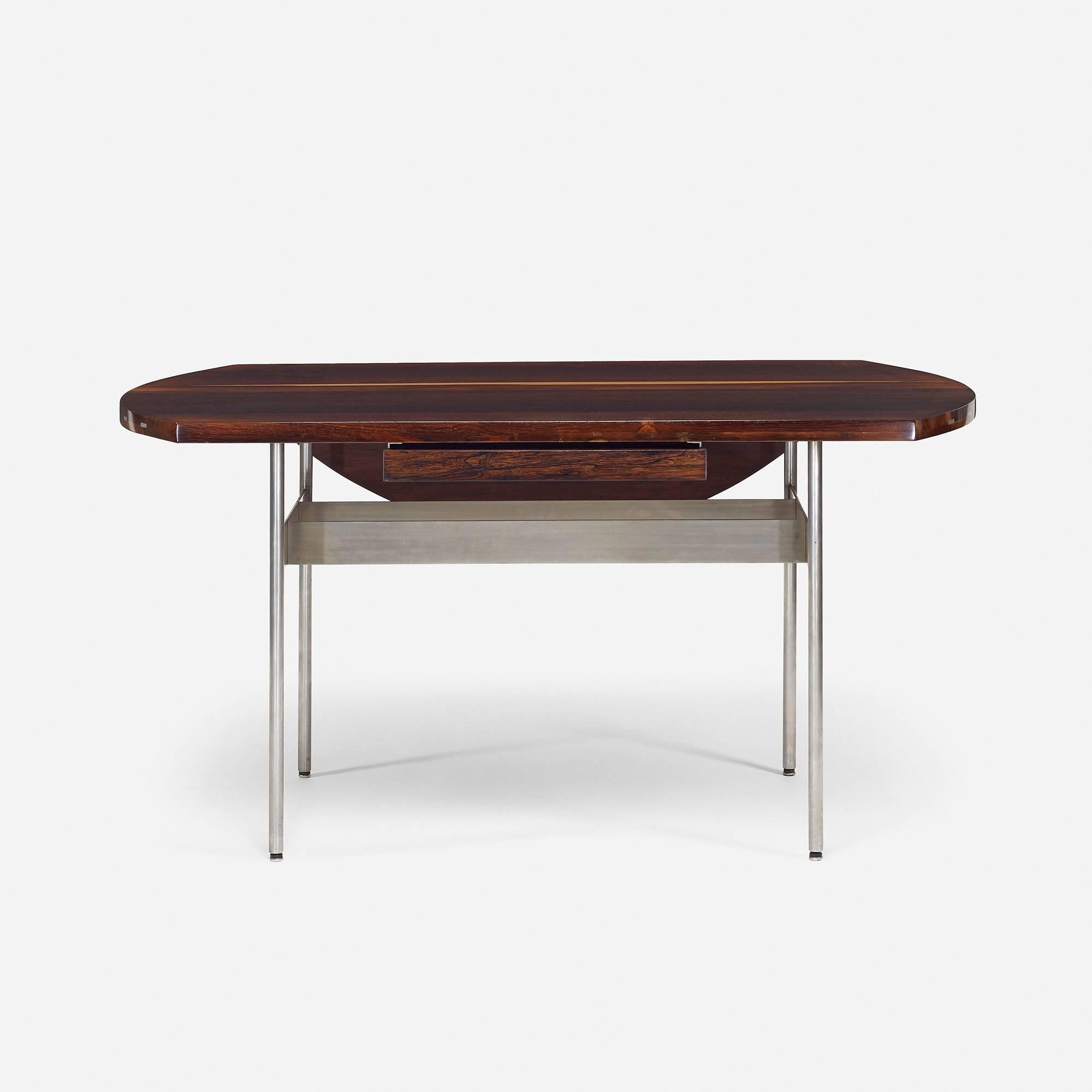 Desk features solid rosewood throughout including secondary woods - inset aluminum splines in desk top with aluminum legs and stretcher. Desk features a single drawer and drop-leaf writing surface. Desk measures: 60 W x 47.75 D x 28.5 inches when