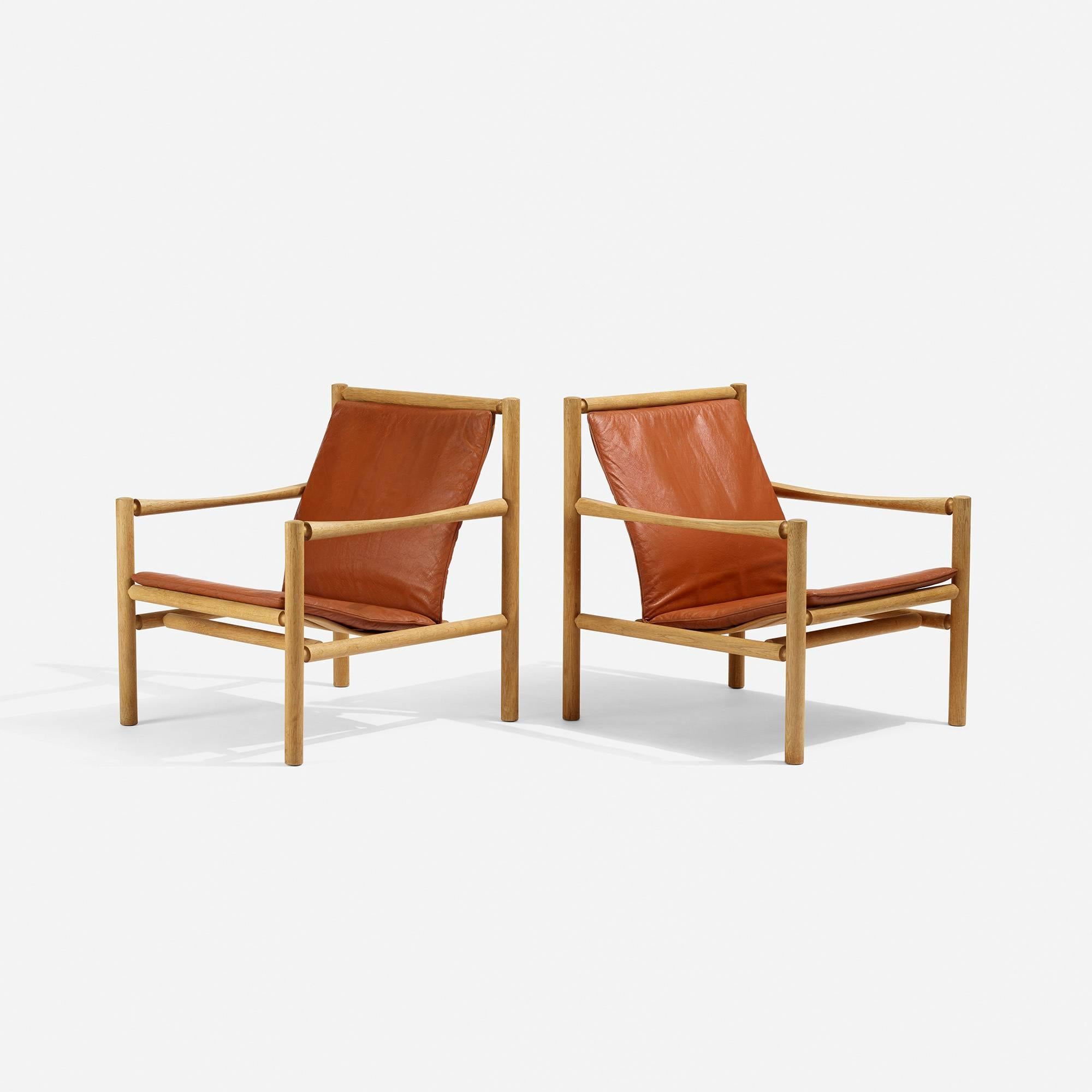 Soulful pair of leather and oak lounge chairs by Jorgen Nilsson.