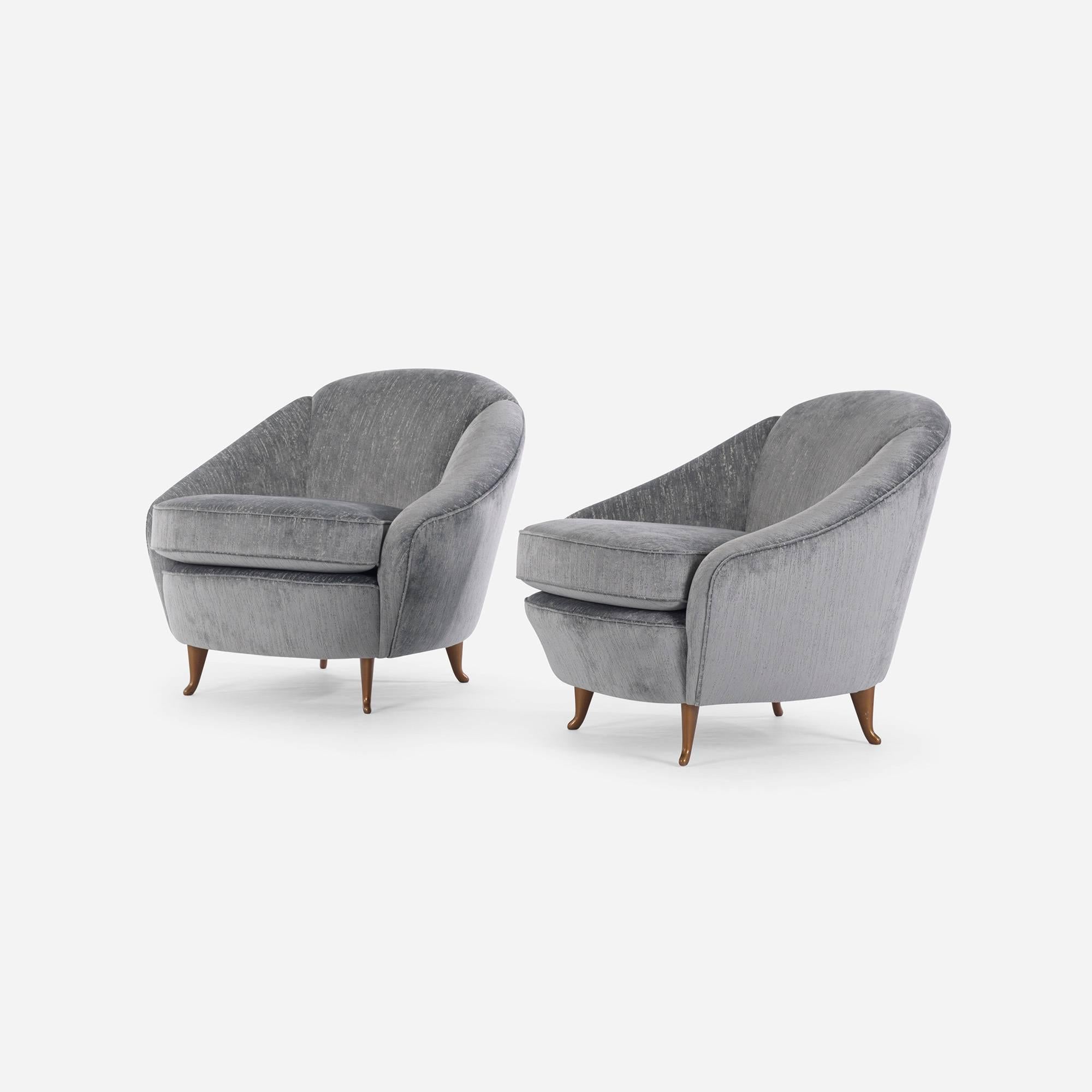 These compact and lively lounge chairs have been recently upholstered in a soft fabric with an mild but intentionally distressed appearance. Color is a greenish grey. Very chic in person.