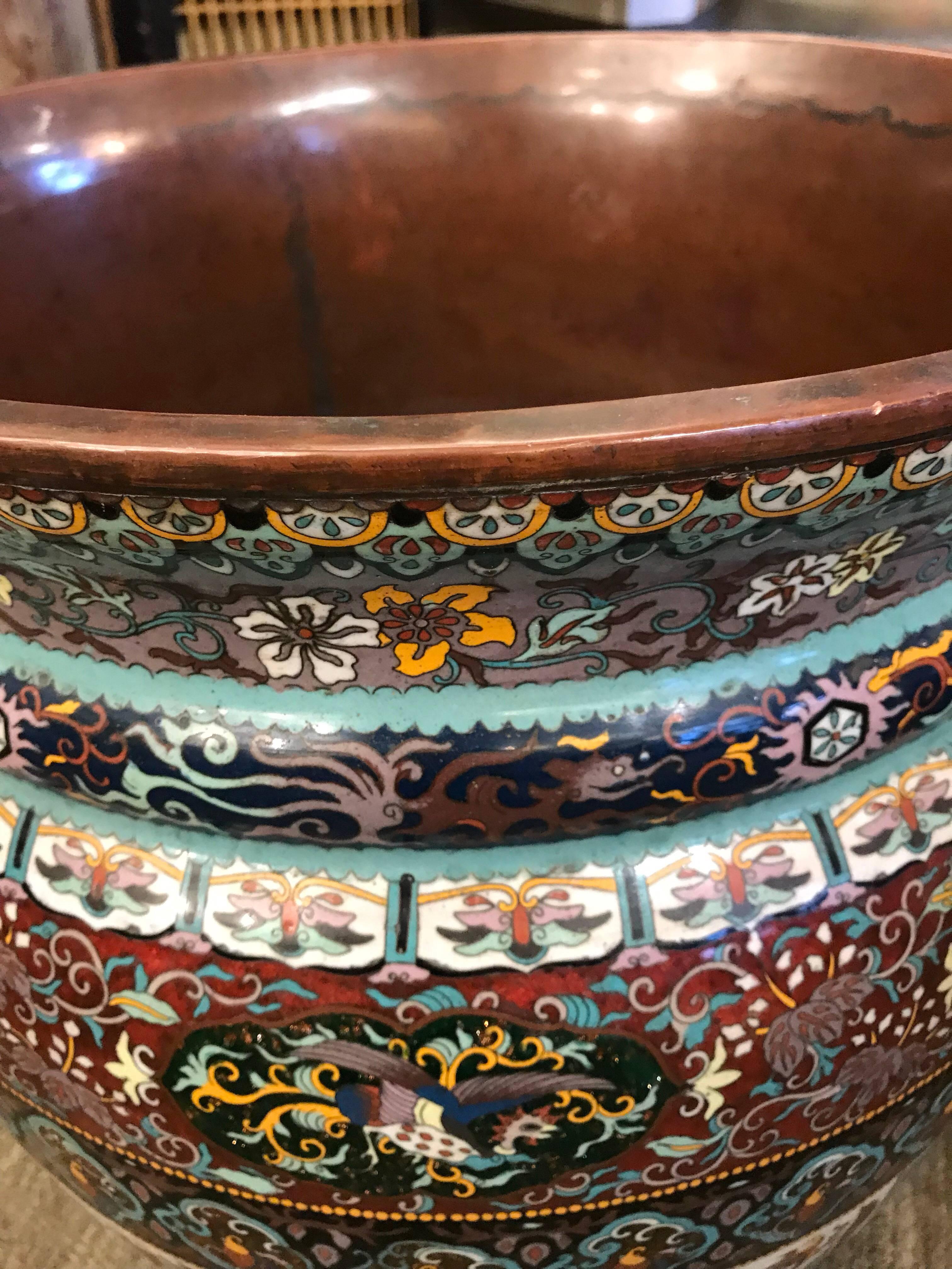 A very large pair of early 20th century Japanese planters, made of cloisonné. With very detailed borders, and gorgeous colors.

These would be perfect indoors to hold large plants, or beautiful under a large table or on a shelf all by themselves.