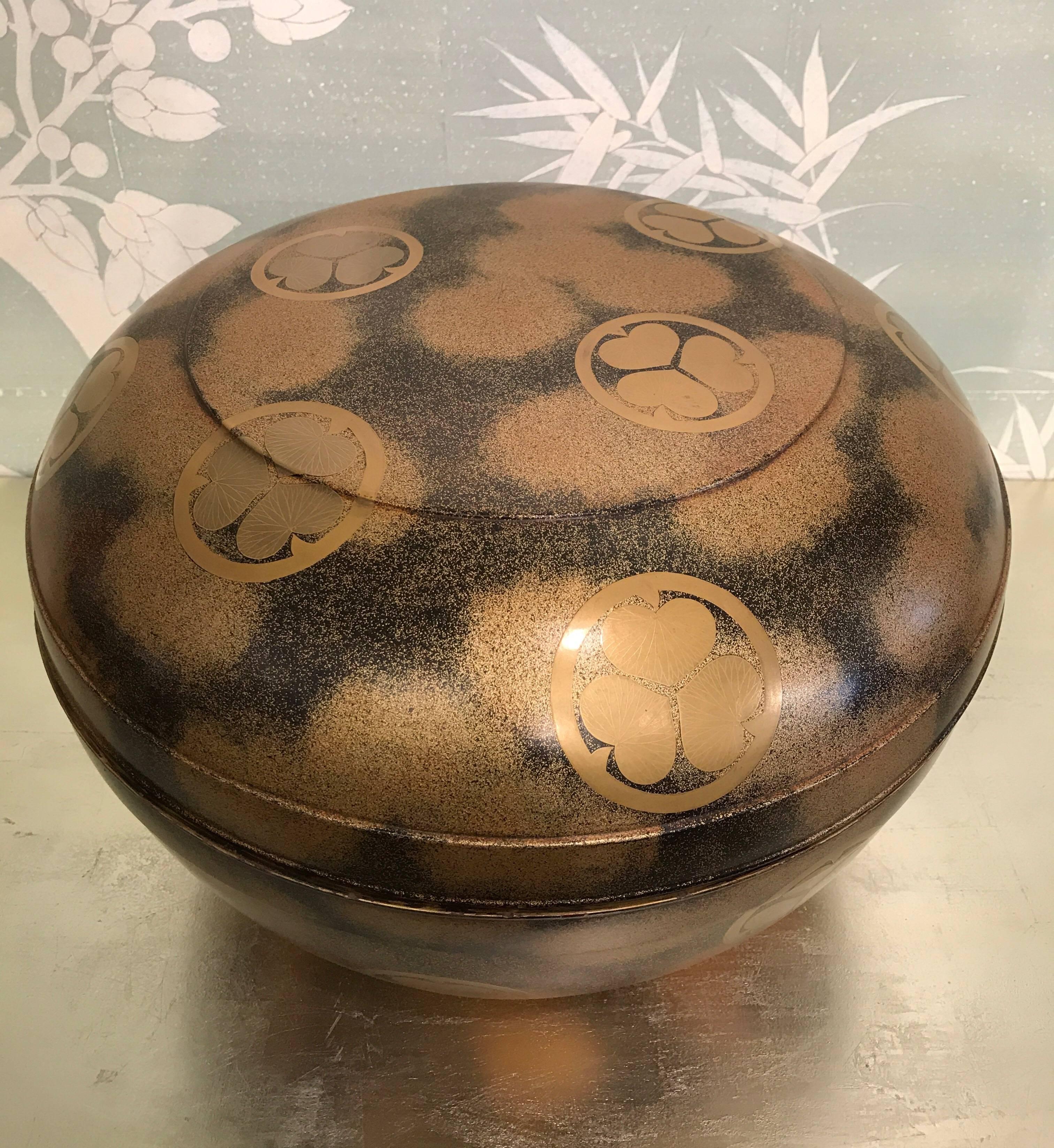 Very large round 19th century Japanese lacquer covered box with pawlonia leaf crests.