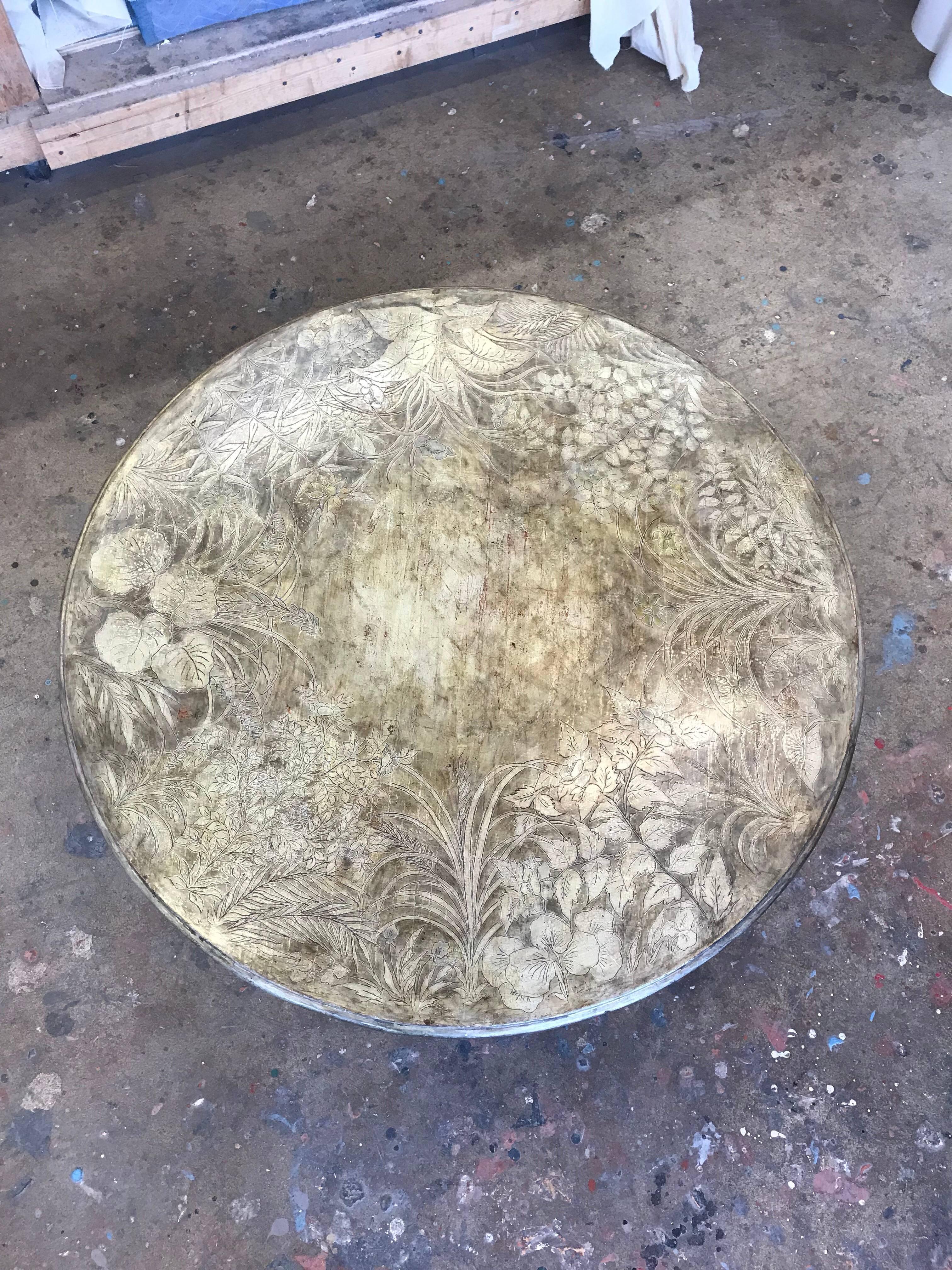 A handmade coffee table by Max Kuehne, circa 1950, with silver leaf finish and incised floral design. Signed Max Kuehne on edge of top. 

Decorative apron, also with incised design.