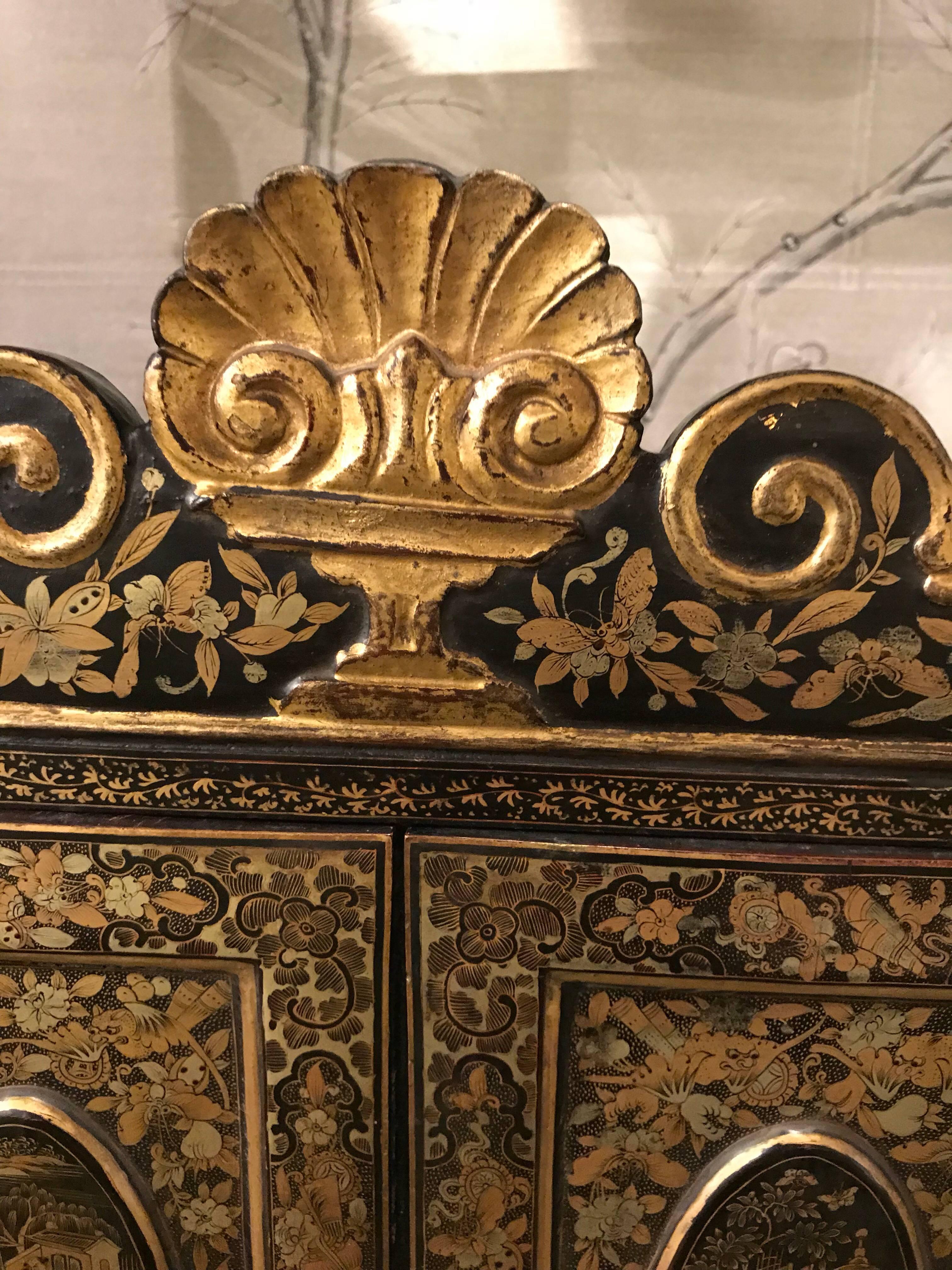 A small 19th century Chinese black lacquer export style cabinet.

With detailed landscape design and interior drawers.

Hand-painted design in gold.