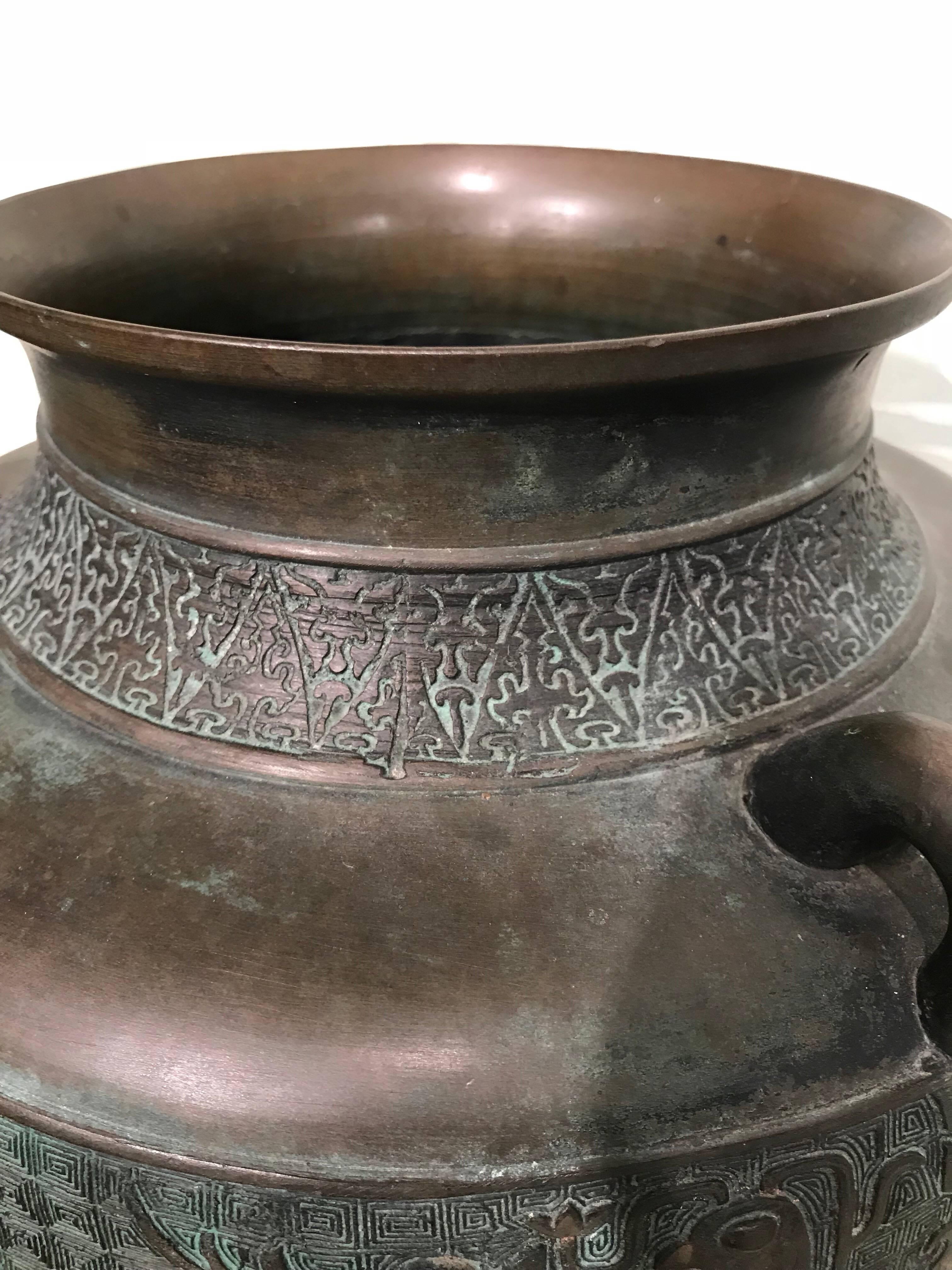 A large early 20th century Japanese bronze vase with design.