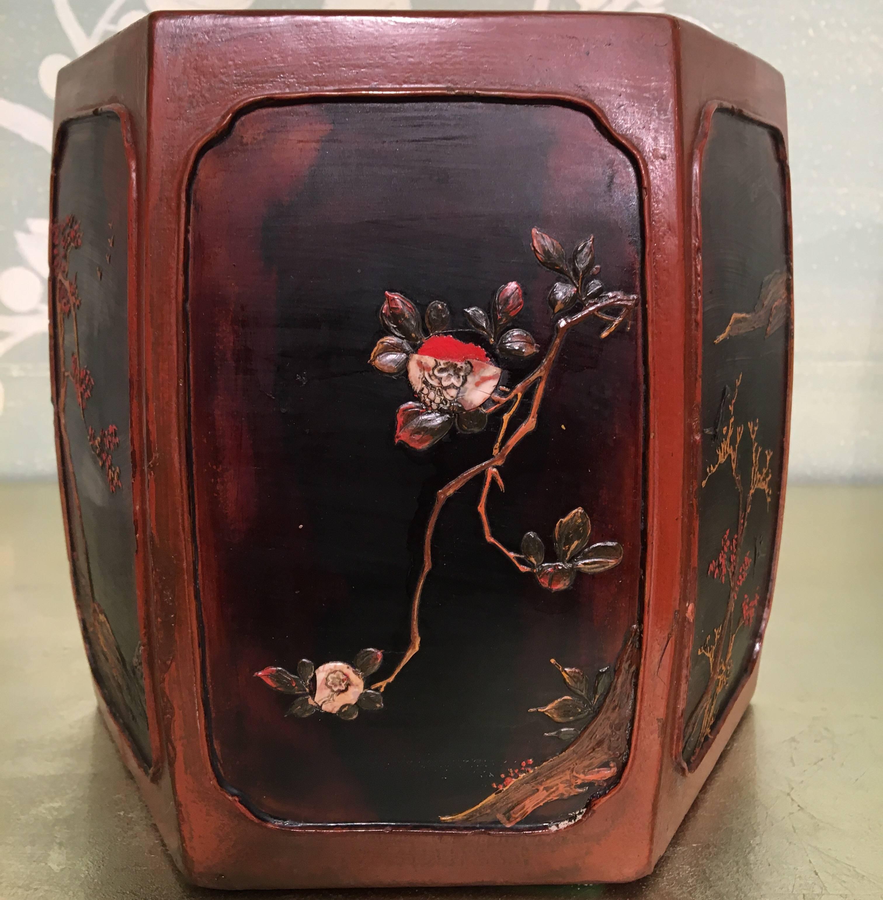 A pair of hexagonal Japanese lacquer cache pots, with reserves of branches and flowers.