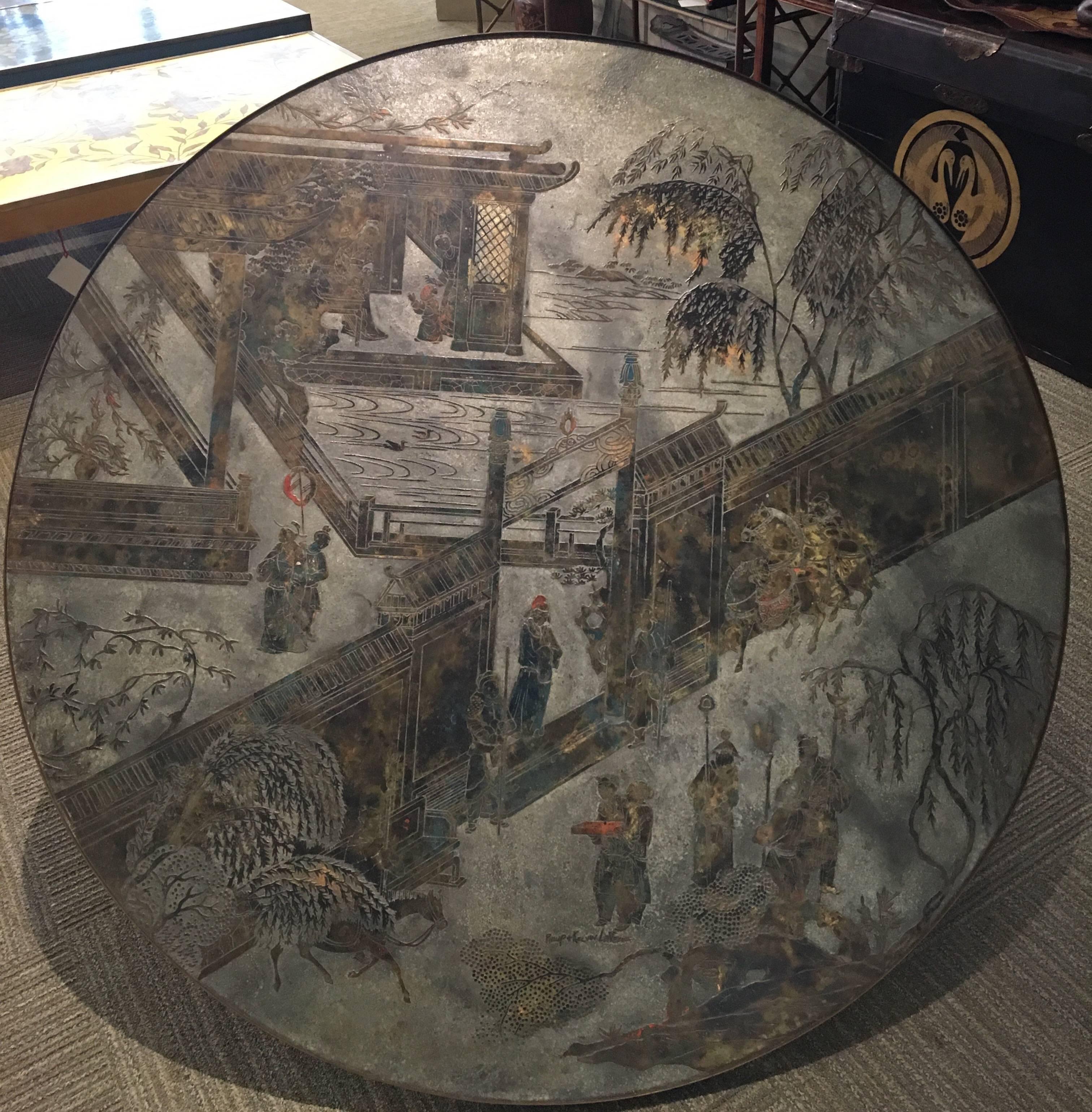 A large round Chan coffee table with figures and landscapes by Philip and Kelvin LaVerne. Signed by Philip and Kelvin LaVerne.