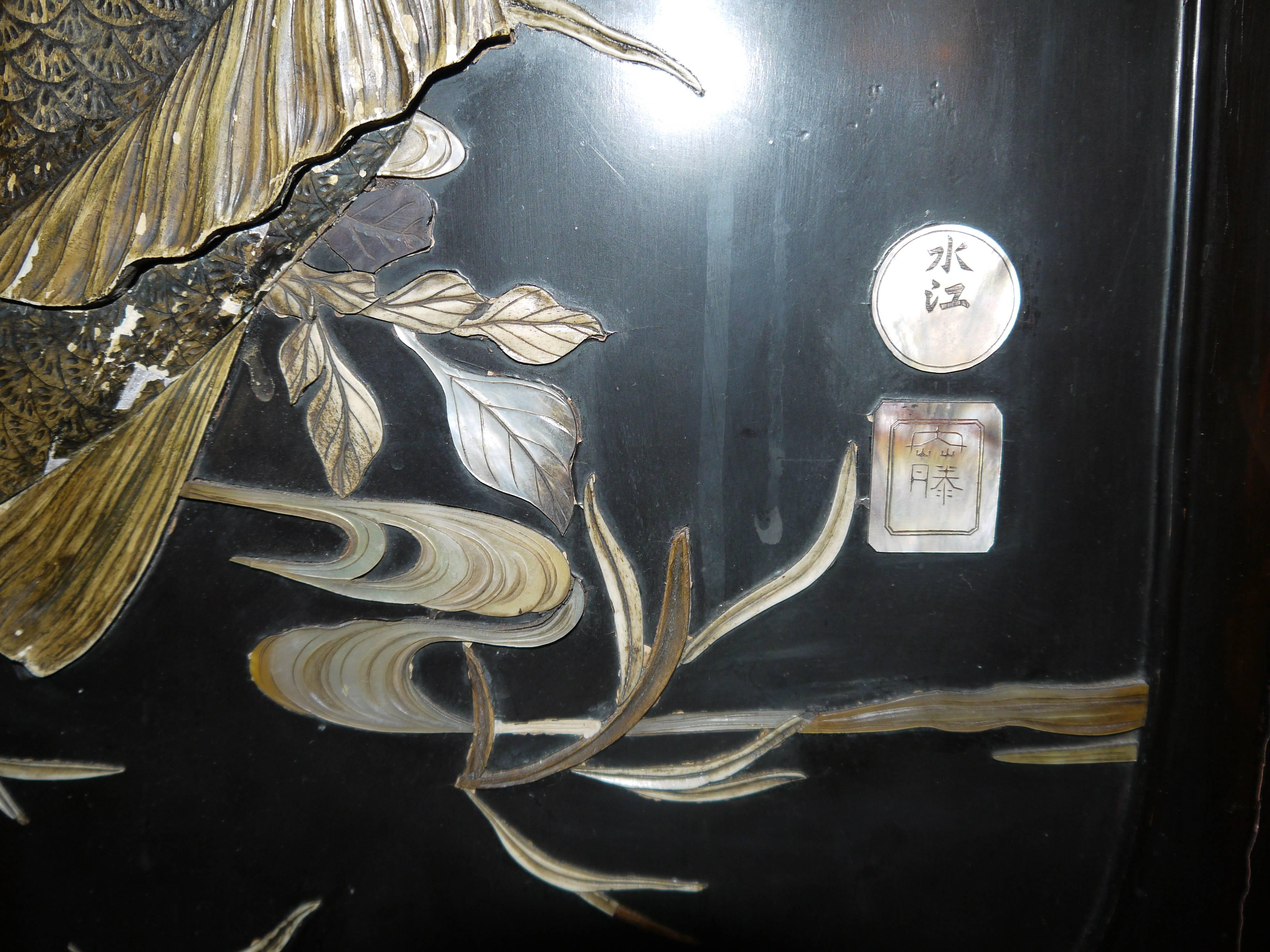 A large panel, ready to hang on the wall, with raised design of carp, water and plants. The carving is highly detailed.