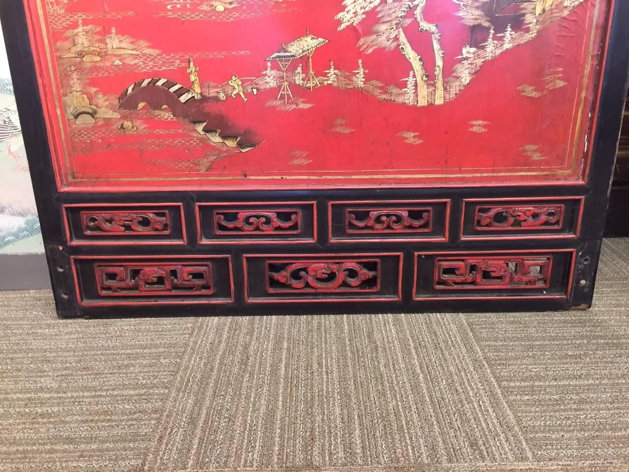 A beautiful, large scale Chinese panel, hand painted in gilt and darker tones on a red lacquer background, and framed with an open work border at the top and base.

Design is of figures and pavilions among water and mountains. There is openwork