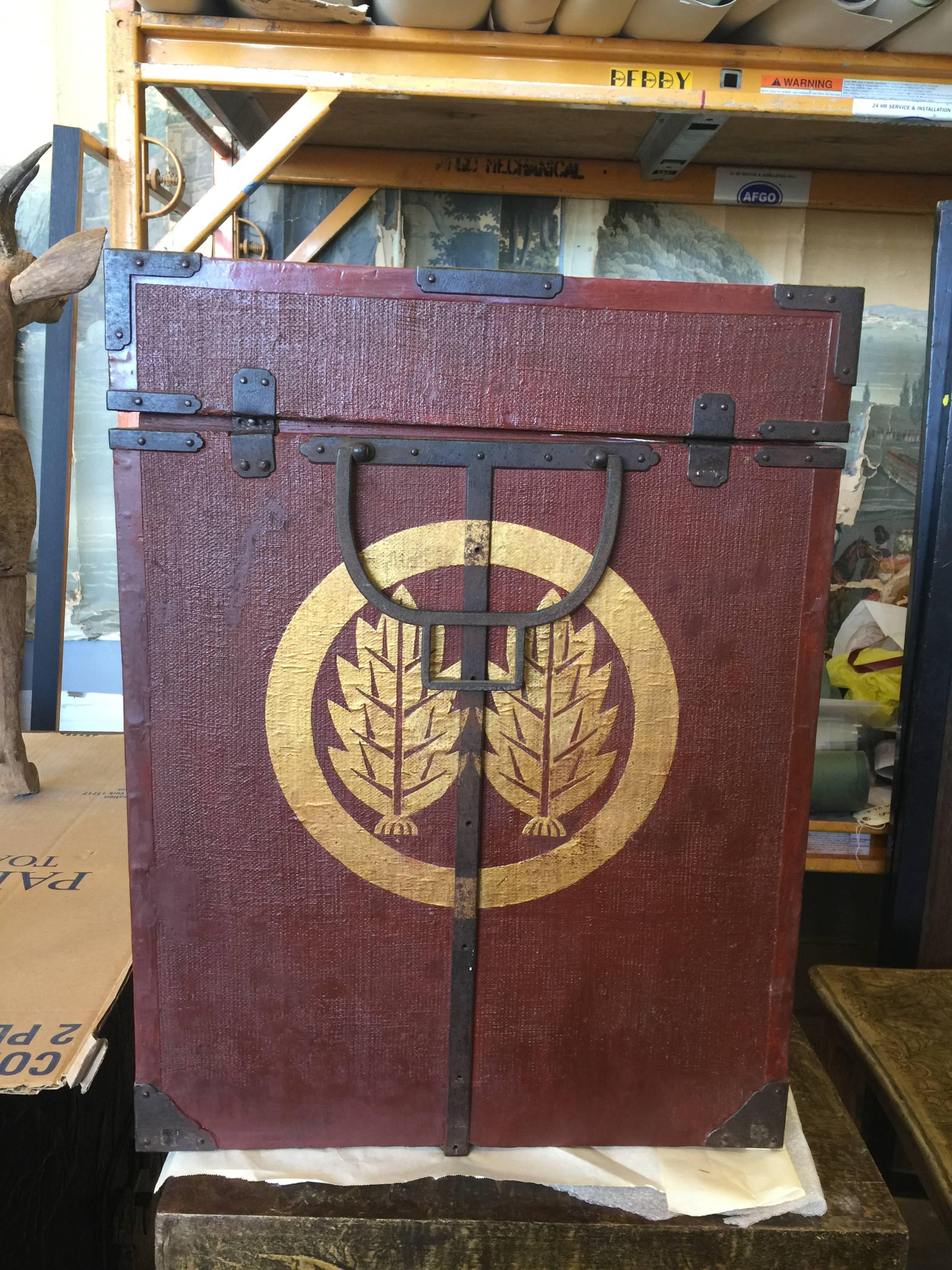 Perfect as side tables, this pair of antique Hitsu 'Box' of Yoroi 'Armor' are dark red, with hand-painted gold crests and metal hardware.