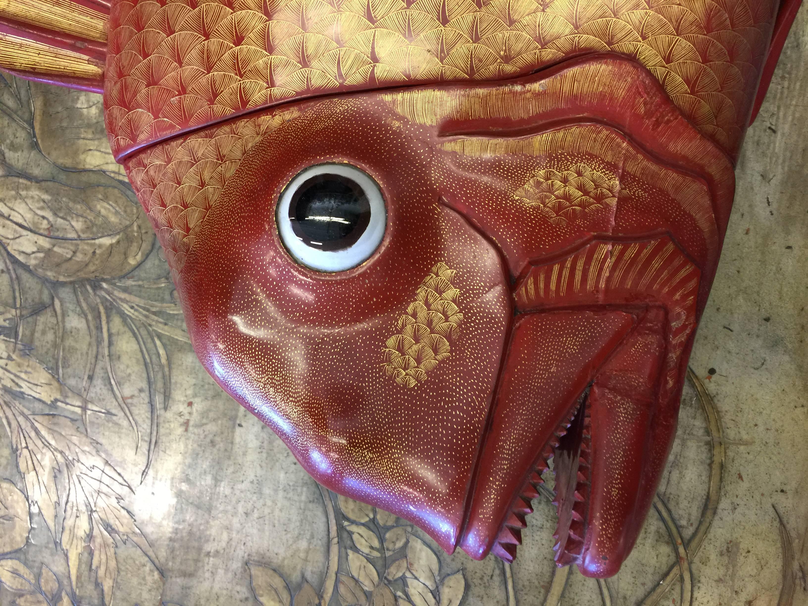 A wonderfully expressive massive red lacquer box, Japanese, in the shape of a fish. With line details in gold.