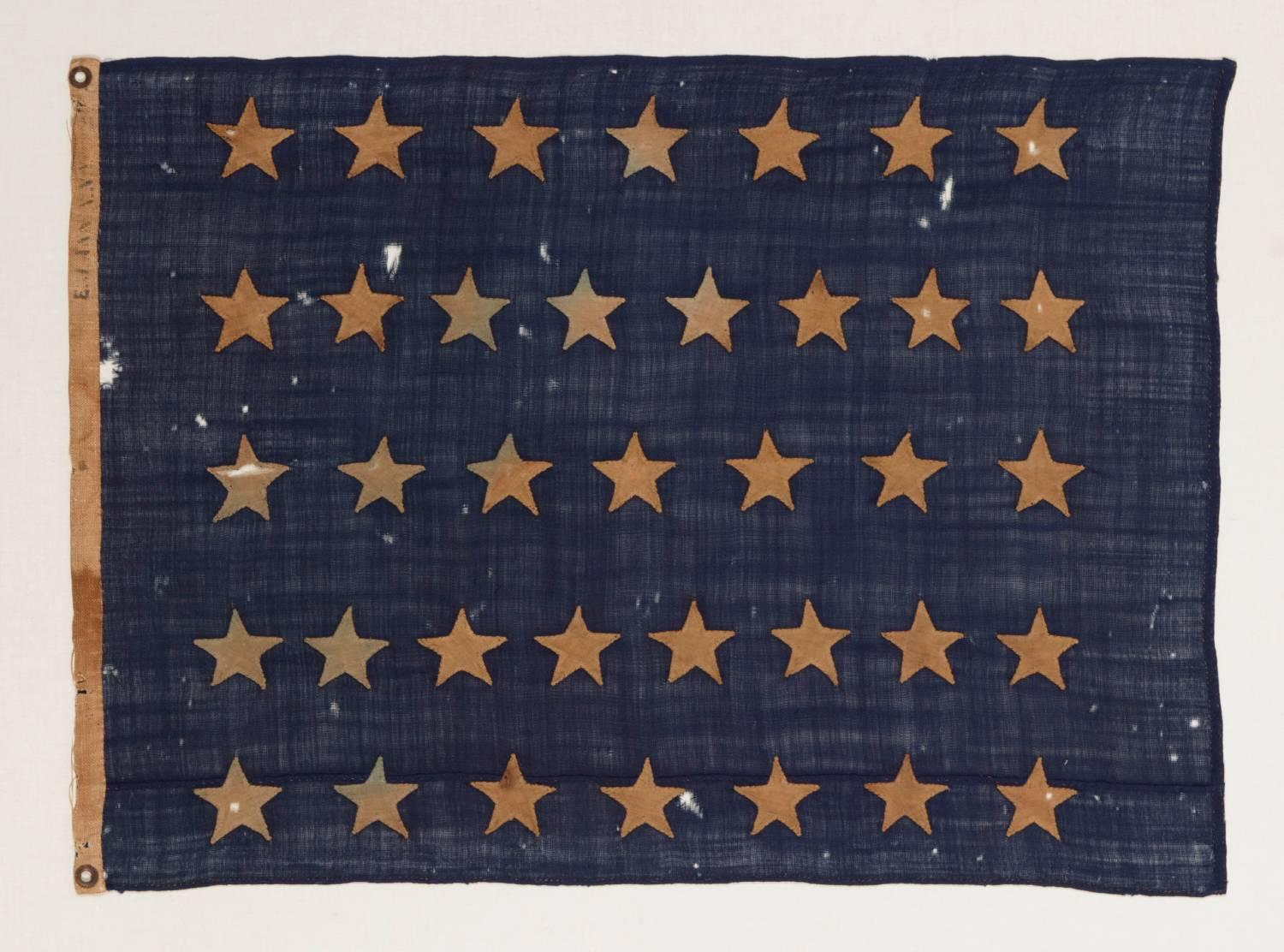 U.S. NAVY JACK WITH 37 STARS, AN ENTIRELY HAND-SEWN EXAMPLE WITH SINGLE-APPLIQUÉD STARS, MADE BY ANNIN IN NEW YORK CITY BETWEEN 1867 AND 1876, RECONSTRUCTION ERA, NEBRASKA STATEHOOD:

 Like the British Royal Navy, American vessels flew three