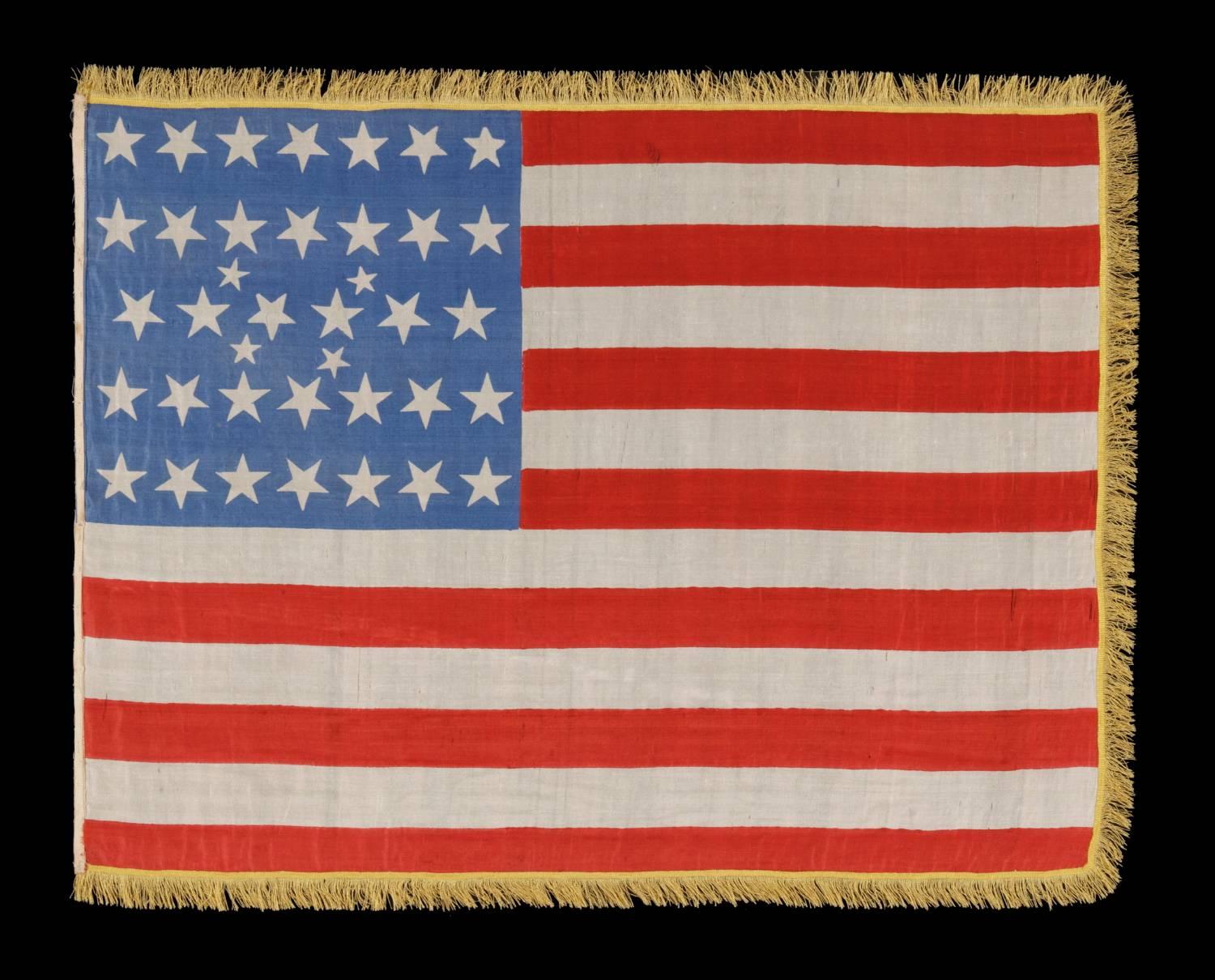 38 stars in an extremely rare lineal configuration that has 4 tiny stars embedded in the pattern, formerly in the collection of richard pierce and pictured in his text on flag collecting:

38 star American national parade flag, printed on silk,