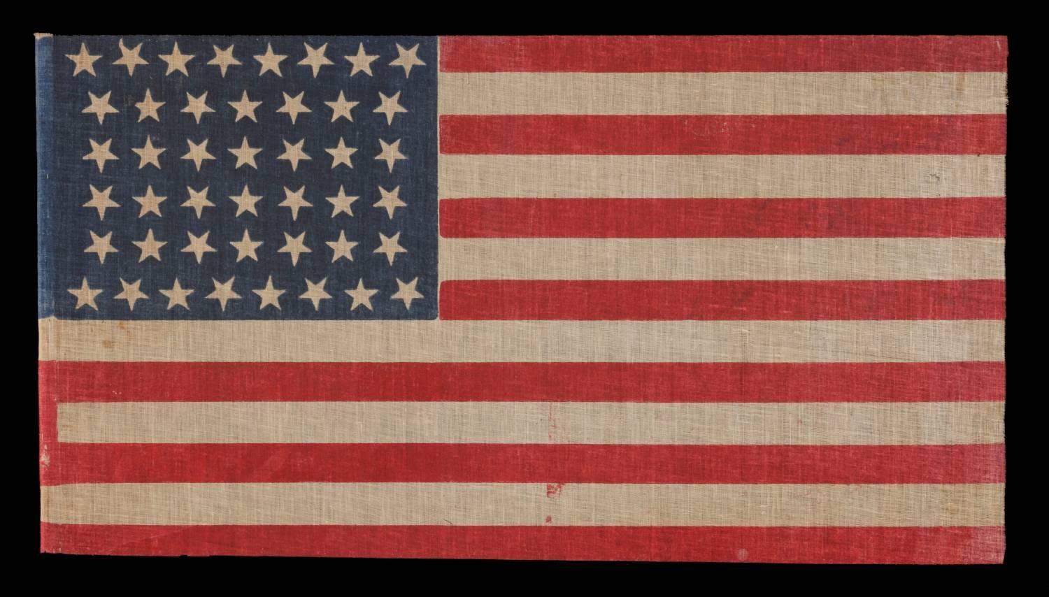 44 dancing or tumbling stars in an hourglass formation, Wyoming statehood, 1890-1896:

44 star American parade flag printed on coarse, glazed cotton. These are configured in rows of 8-7-7-7-7-8, with the top and bottom rows offset so that they