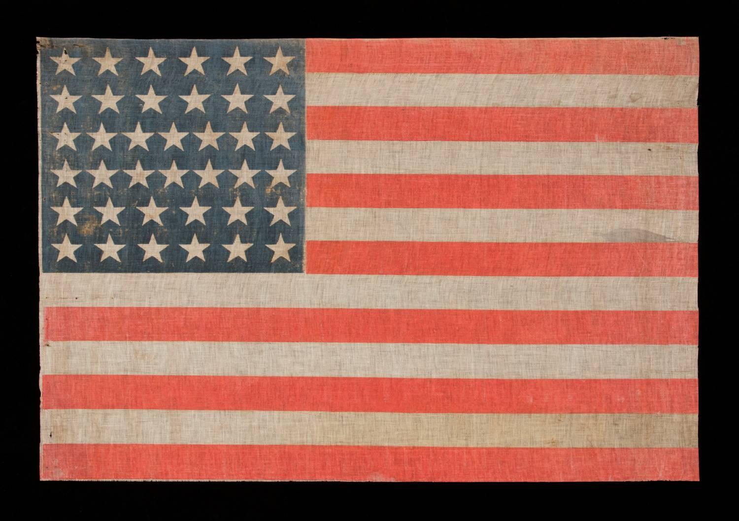 38 stars on a parade flag with especially large-scale and beautiful, persimmon red stripes, Colorado statehood, 1876-1889:

38 star American national parade flag, printed on coarse, glazed cotton. The stars are arranged in justified rows of
