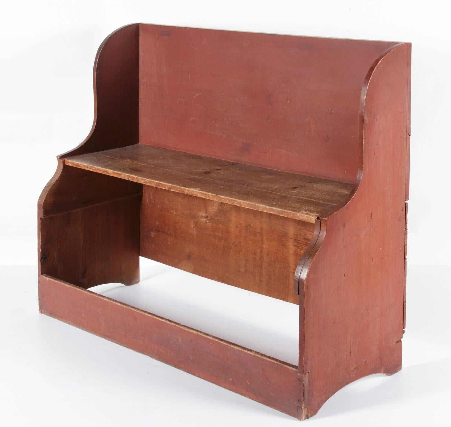 UNUSUAL DEACONS BENCH / BUCKET BENCH IN DRY SALMON RED PAINT, PROBABLY OF NEW ENGLAND ORIGIN, CA 1830-50:

Call it a settle bench, bucket bench, or simply a high-back bench. Whatever the case may be, it is a graceful and highly unusual piece of