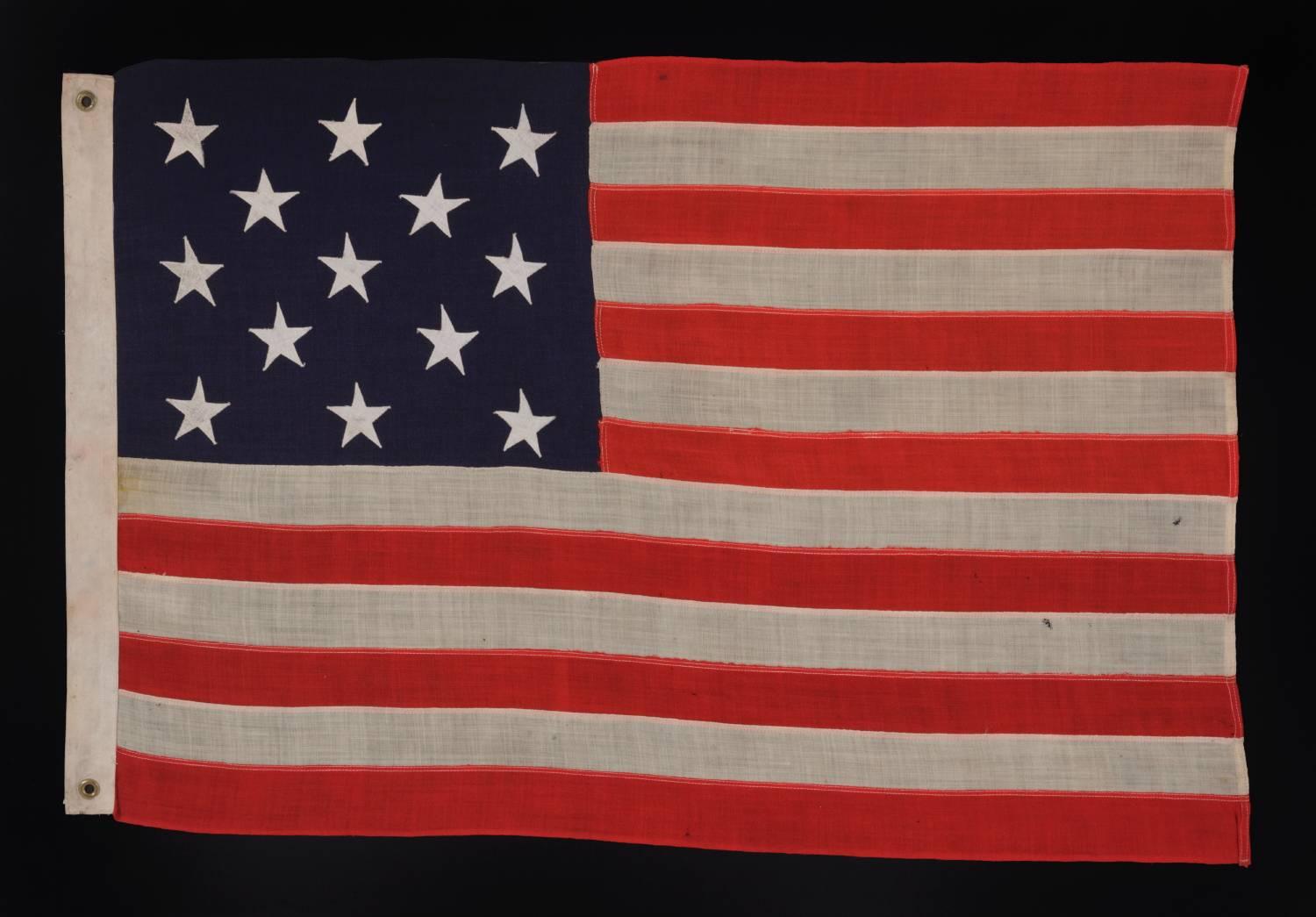 13 Stars arranged in A 3-2-3-2-3 PATTERN on a small-scale antique american flag made in the period between the last decade of the 19th century and the first quarter of the 20th:

This 13 star antique American flag is of a type made during the last