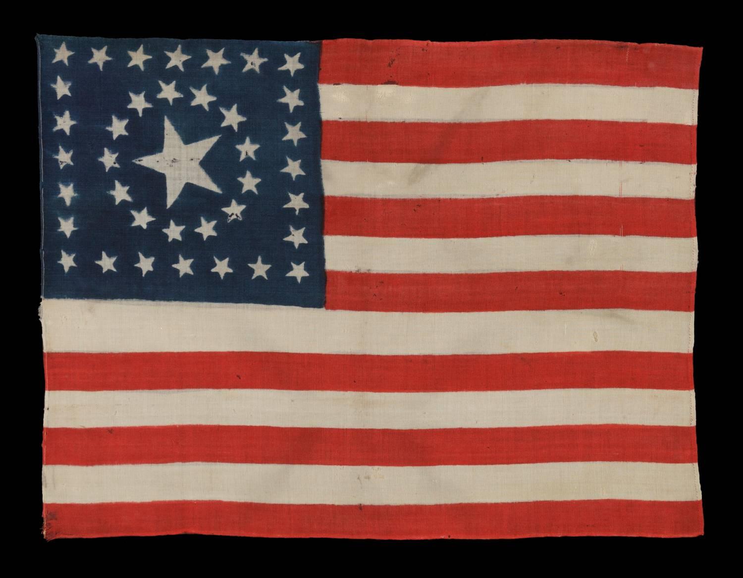 38 STARS IN A RARE CIRCLE-IN-A-SQUARE MEDALLION WITH A HUGE CENTER STAR, MADE FOR THE 1876 CENTENNIAL CELEBRATION, PROBABLY BY HORSTMANN BROS. IN PHILADELPHIA: 

38 Star American national parade flag with an especially rare type of medallion star