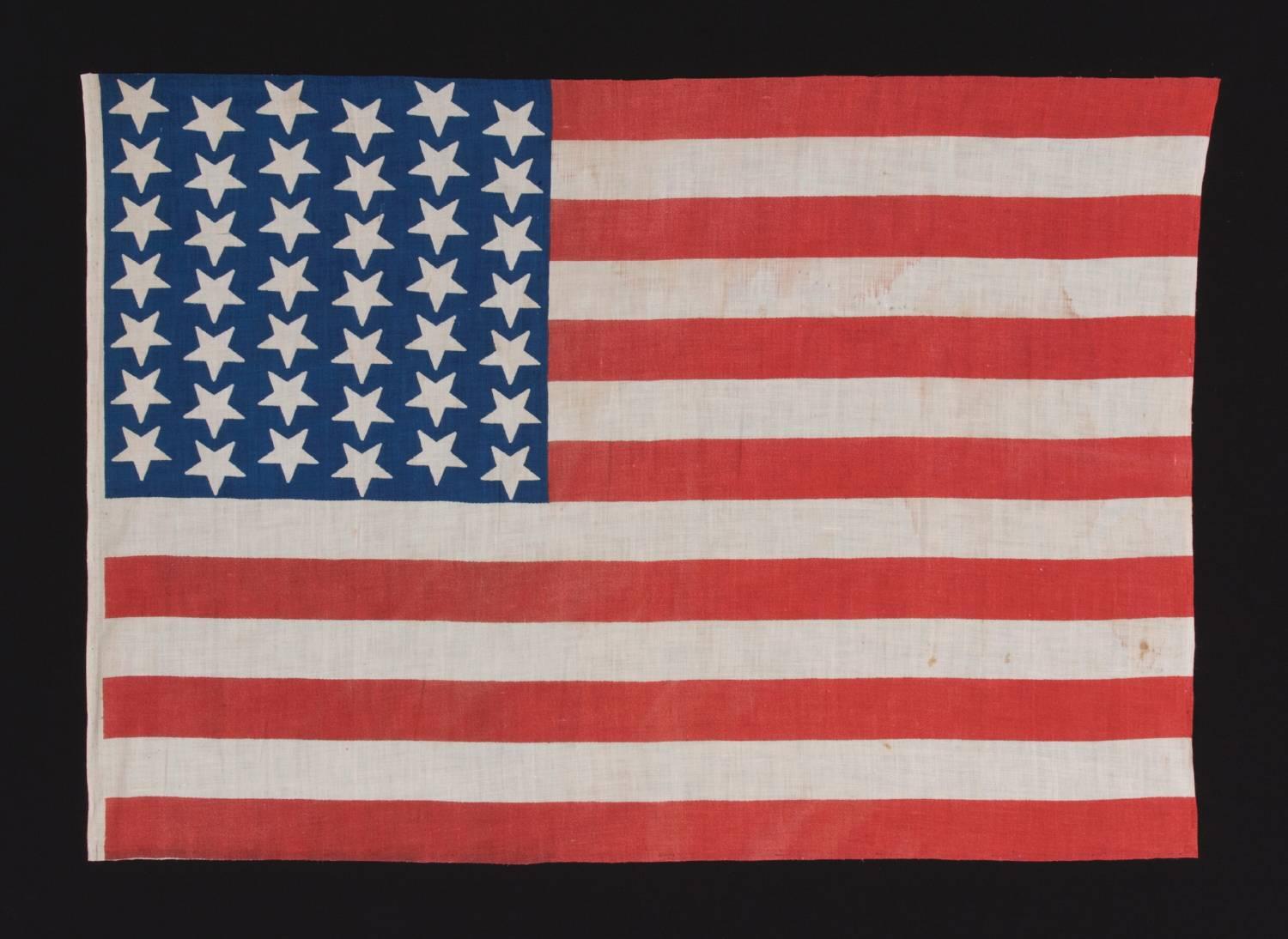 42 Upside down stars in a wave configuration on a brilliant blue canton, 1889-1890, Washington statehood, an unofficial star count:

 42 star American national parade flag, printed on plain weave cotton. The stars, that are especially large in