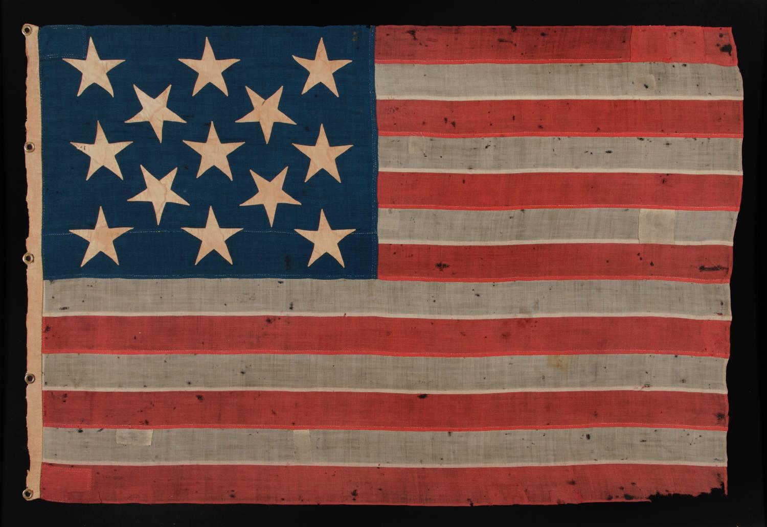 13 large and strikingly visual stars on a U.S Navy small boat ensign, entirely hand-sewn, circa 1884-1887: 13 star American national flag of the type flown by the U.S. Navy. These flags were flown at the stern, from a gaff, or from the yard-arm on a