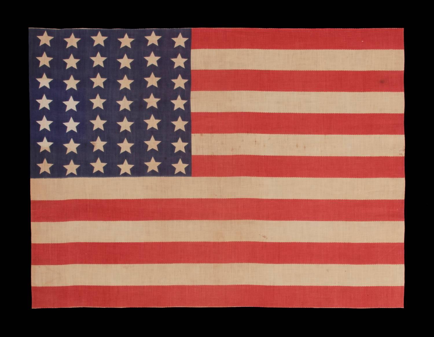 42 stars in a wave configuration of lineal columns, never an official star count, 1889-1890, Washington Statehood:

 42 star American parade flag, printed on cotton. This interesting star pattern is called a “wave” configuration. Note how the