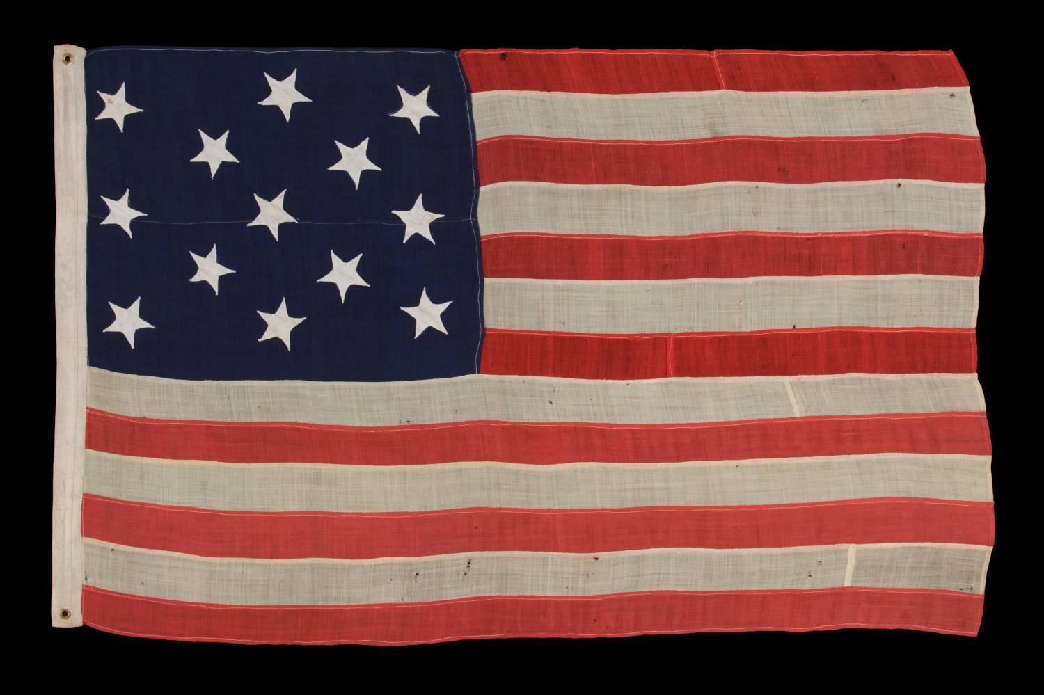 13 hand-sewn stars on an antique American flag of the 1876 era, probably a U.S. Navy small boat ensign:

13 star American national flag of the type flown by the U.S. Navy in the 1870s-1880s period. Because the Navy's flags of this era were made in