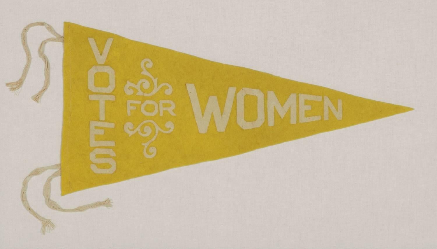 Triangular felt suffragette pennant with an interesting design and text that reads: 