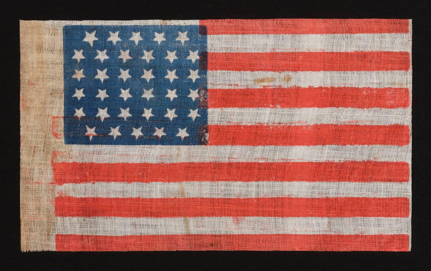 34 STARS IN A LINEAL ARRANGEMENT THAT RESULTS IN A CONFIGURATION THAT I HAVE TERMED "GLOBAL ROWS," MADE DURING THE OPENING TWO YEARS OF THE CIVIL WAR, 1861-63, KANSAS STATEHOOD: 

34 star American national flag, printed on fine, glazed