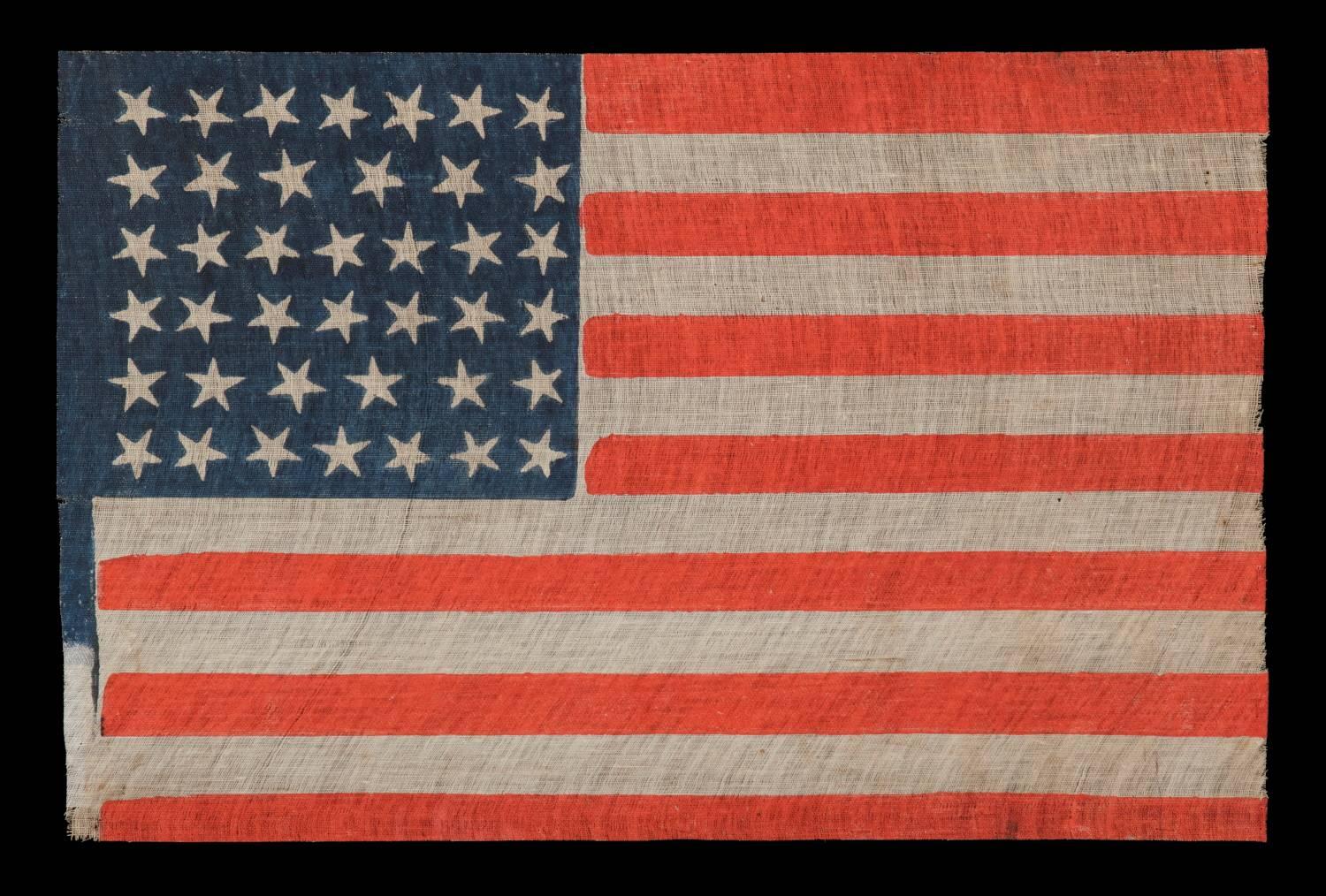 40 STARS, AN EXTREMELY SCARCE EXAMPLE AND AN UNOFFICIAL STAR COUNT, ACCURATE FOR JUST SIX DAYS, SOUTH DAKOTA STATEHOOD, 1889: 

40 star American national parade flag, printed on coarse, glazed cotton. During the 3rd quarter of the 19th century, it