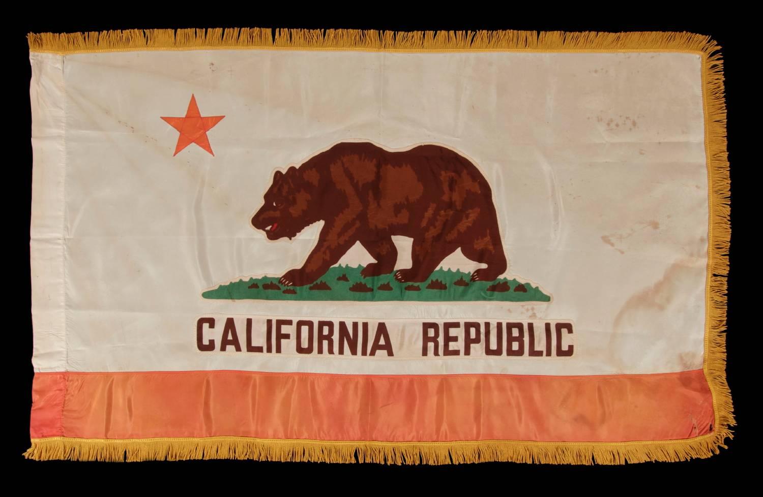 California State Flag, with especially attractive coloration and a gold silk fringe, made by Emerson Mfg. Co. In San Francisco, circa 1940-1950:

Early state flags fall between very scarce and extraordinarily rare in the antiques marketplace. One