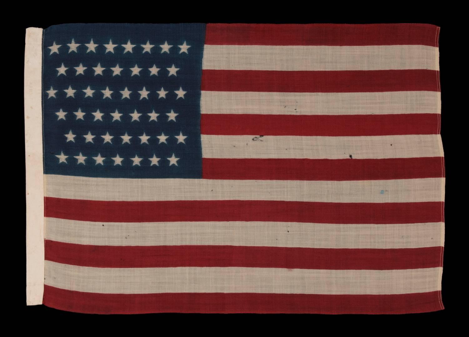 44 STARS IN ZIGZAGGING ROWS ON A PRESS-DYED WOOL AMERICAN FLAG, PROBABLY MADE BY THE HORSTMANN COMPANY IN PHILADELPHIA, POSSIBLY FOR USE AS A MILITARY CAMP COLORS, 1890-1896, REFLECTS WYOMING STATEHOOD:

44 star American national flag, press-dyed on